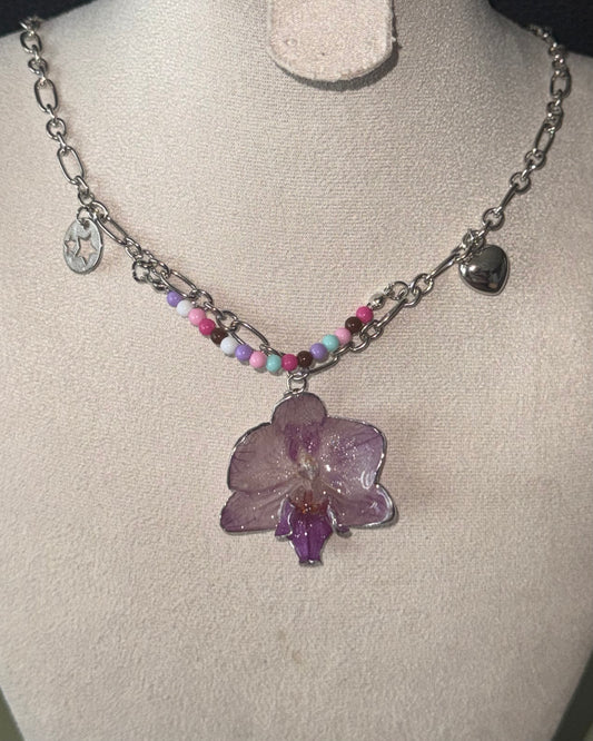 Lilac phalaenopsis necklace with pastel bead strand and silver-toned chain shown from the front