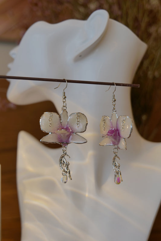 SERAPHIEL — Dendrobium Angel Charm Colour-Shift Earrings by Terra Decode — product photograph 1 showing the handmade botanical earrings.