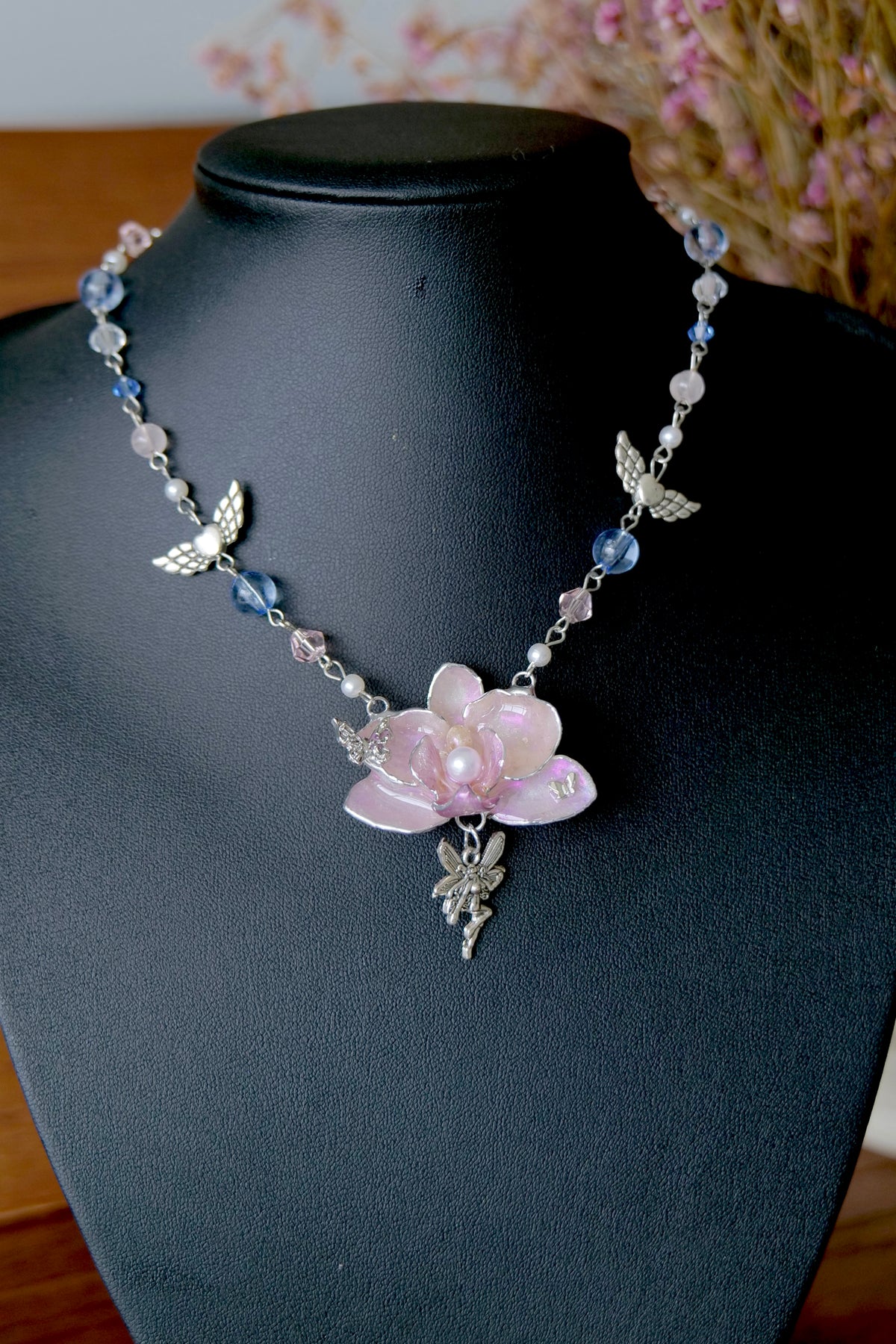 Full view of a one-of-a-kind pink Phalaenopsis angel pendant Y2K necklace by Terra Decode.