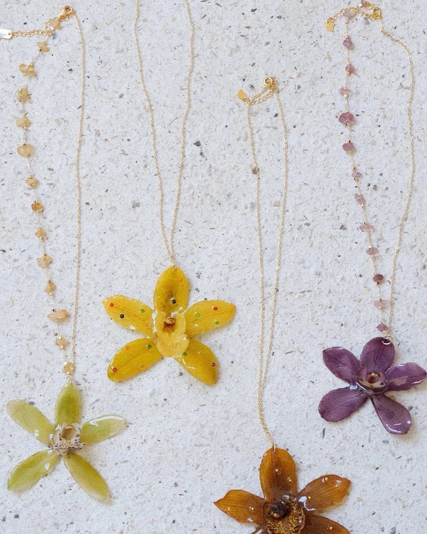 Orchid flower necklaces with resin pendants and gold-tone chains by Terra Decode