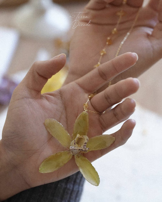Olive green orchid pendant necklace with preserved botanical flower detail by Terra Decode
