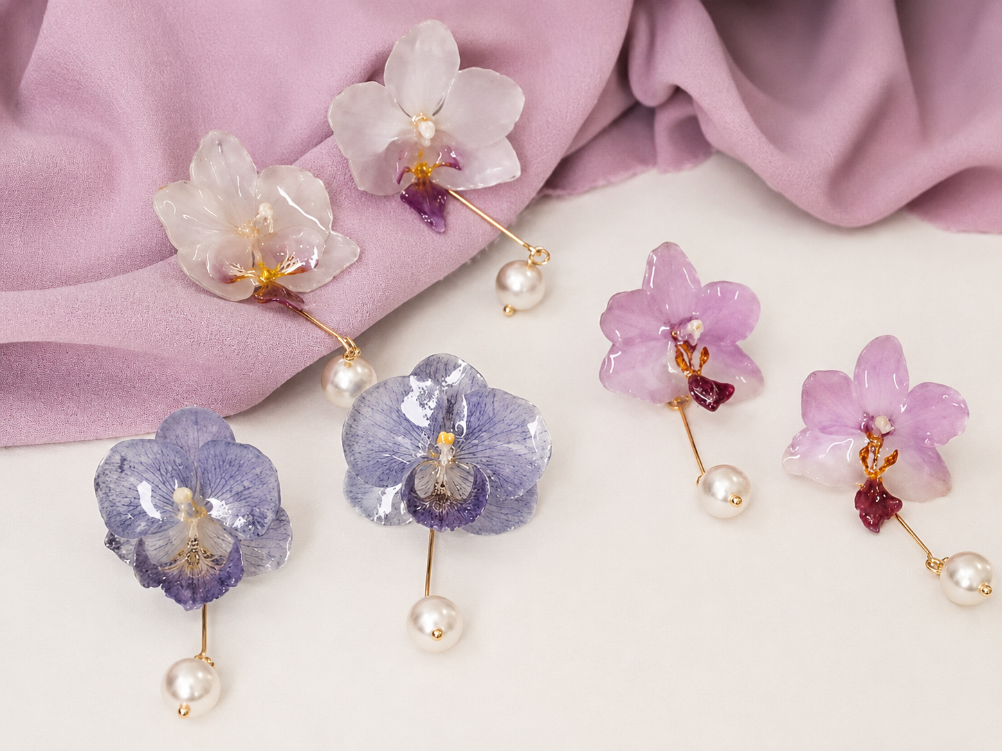 Cream white, soft pink and lavender orchid pearl drop earrings with resin petals on soft fabric by Terra Decode