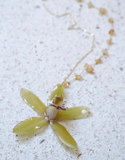 Olive green orchid pendant necklace with preserved botanical flower detail by Terra Decode