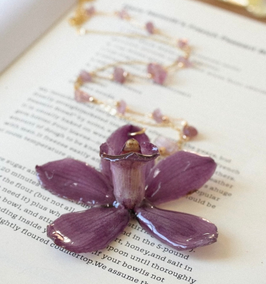 Deep plum orchid pendant necklace with resin flower petals and gold-tone beaded chain by Terra Decode