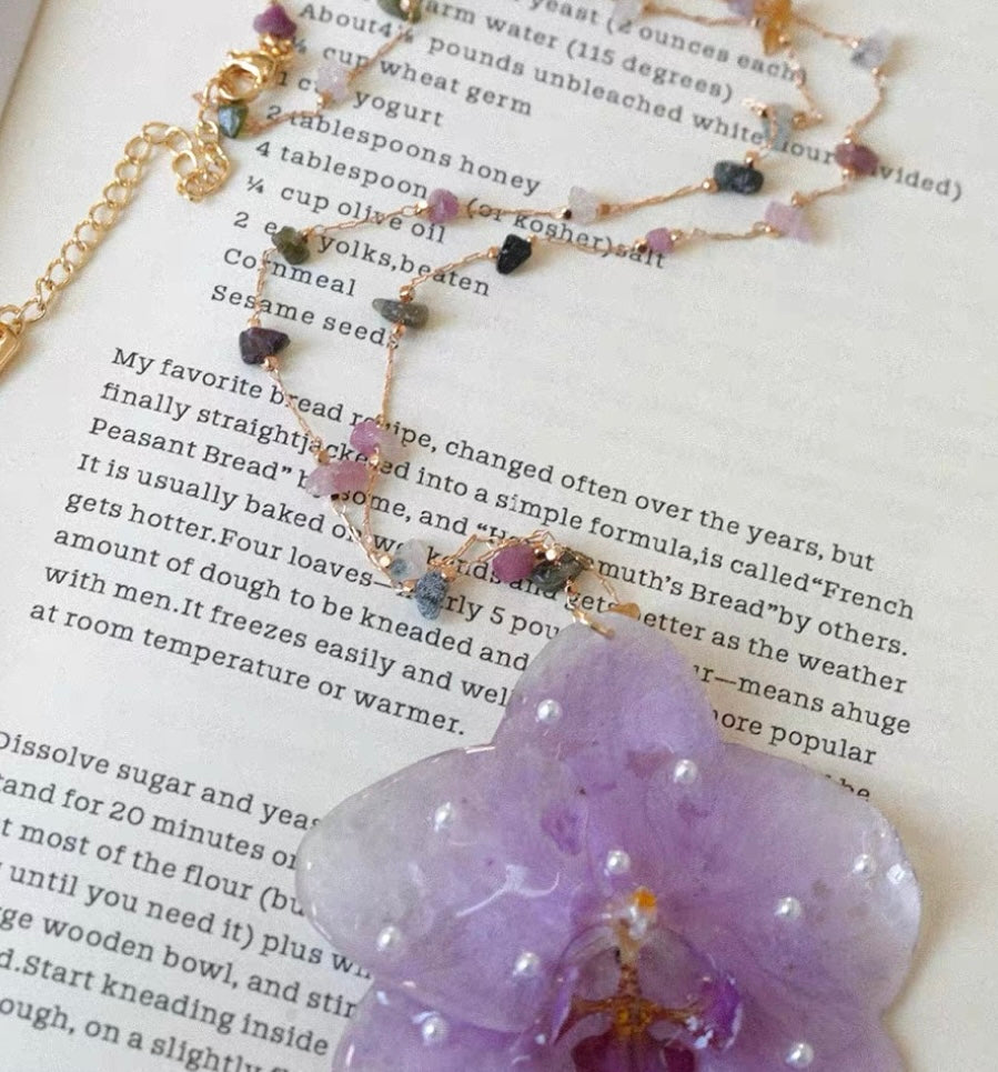 Pearl-dot lilac orchid pendant necklace with resin flower and gold-tone beaded chain by Terra Decode