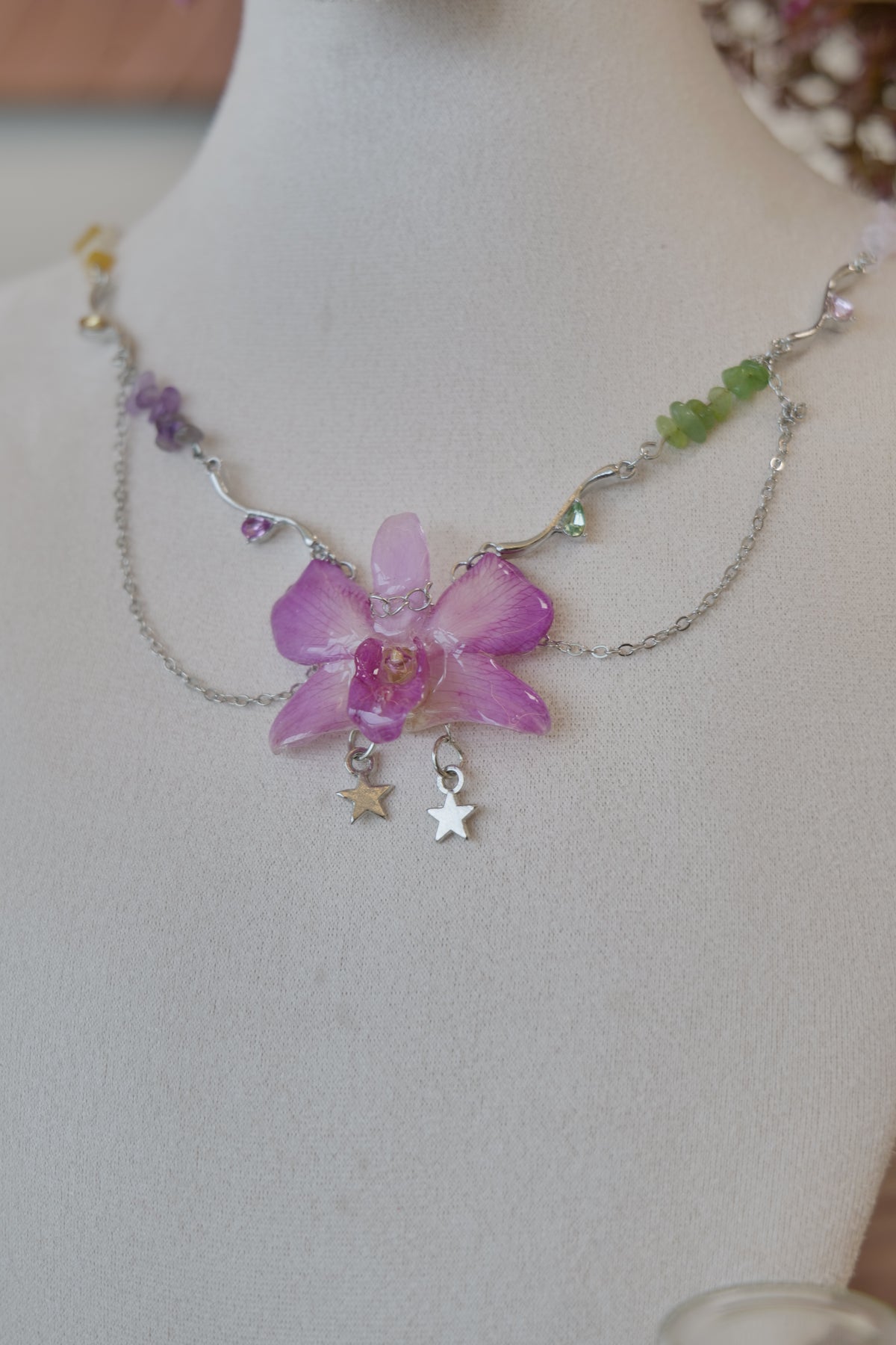 styled front view of purple Dendrobium orchid beaded charm necklace, handmade botanical jewellery by Terra Decode