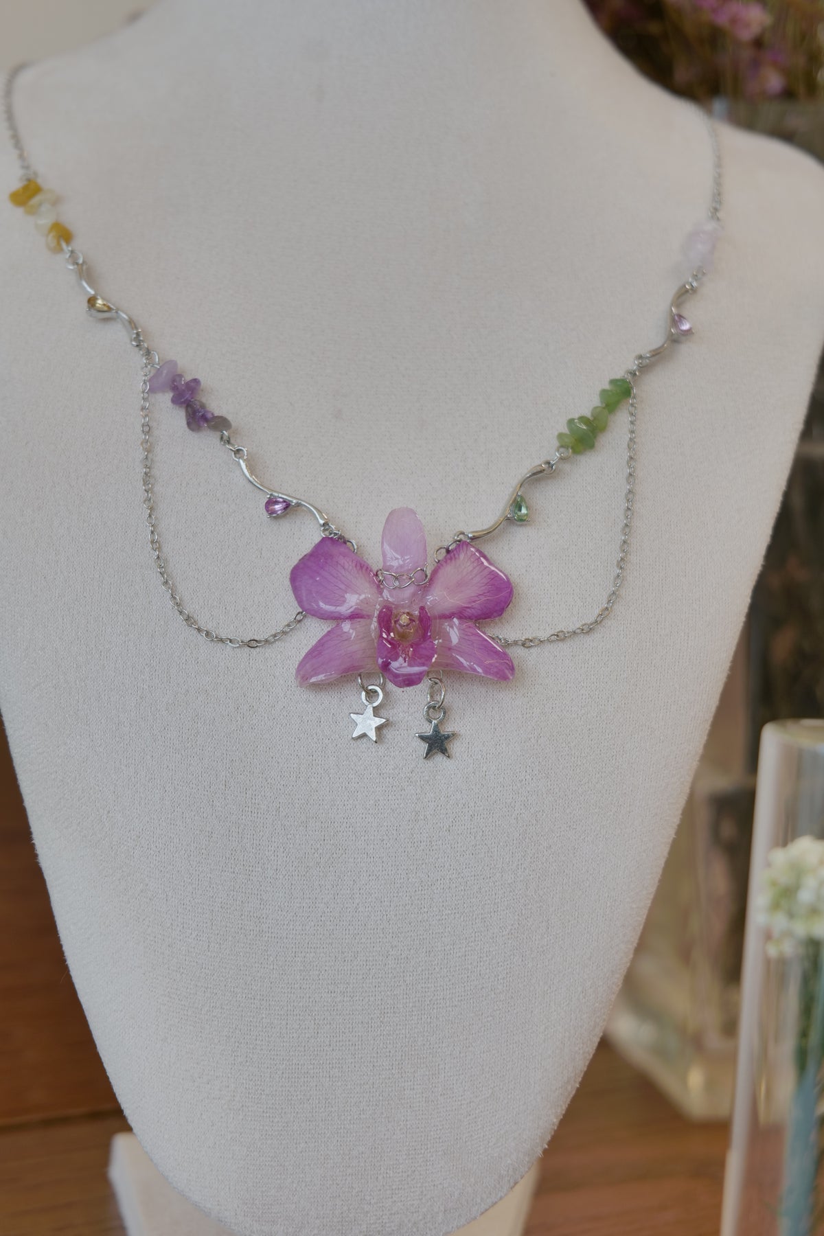 side view of purple Dendrobium orchid beaded charm necklace, handmade botanical jewellery by Terra Decode