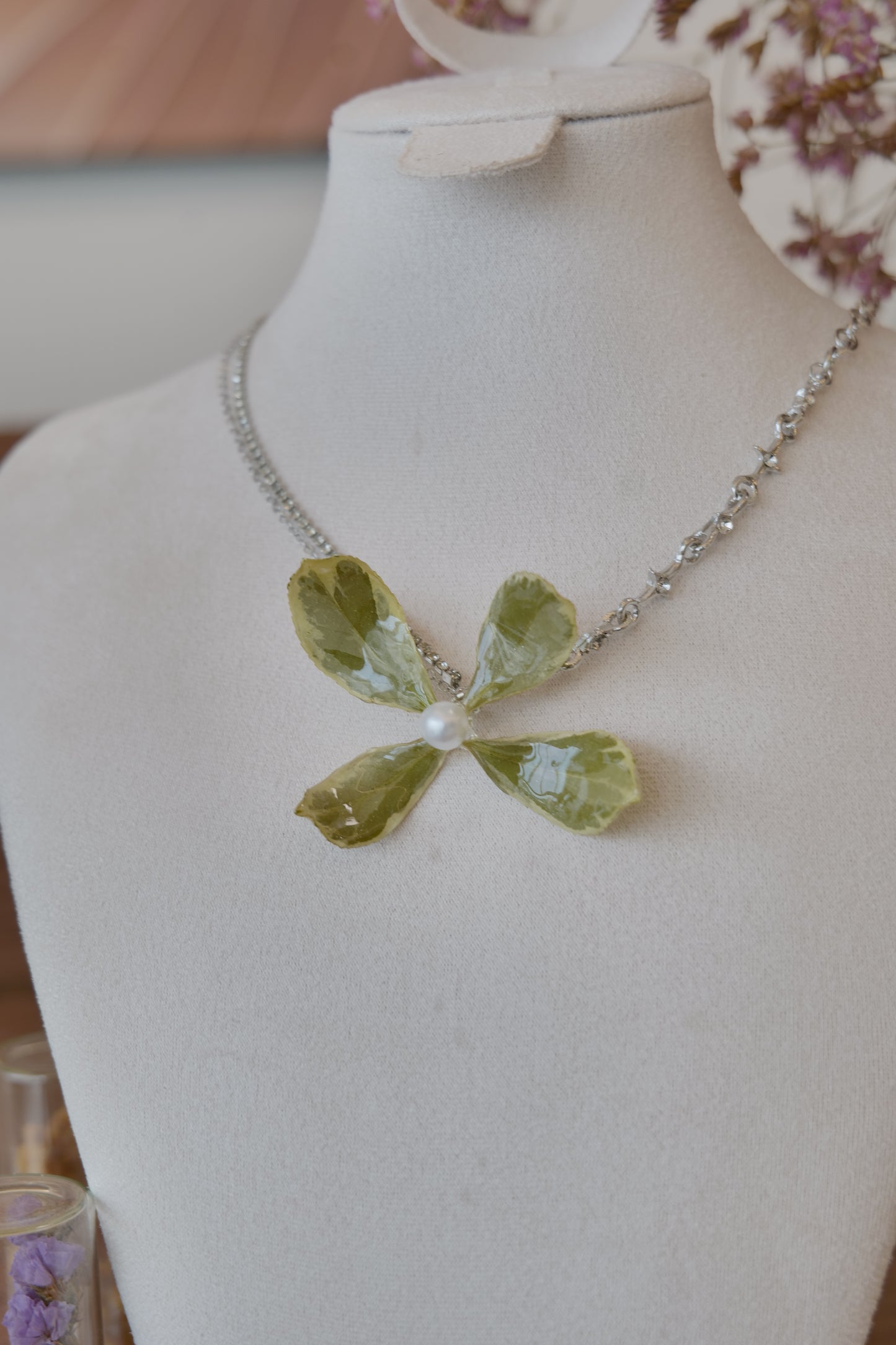 styled front view of Golden Edge Euonymus leaf floral pendant necklace, handmade botanical jewellery by Terra Decode