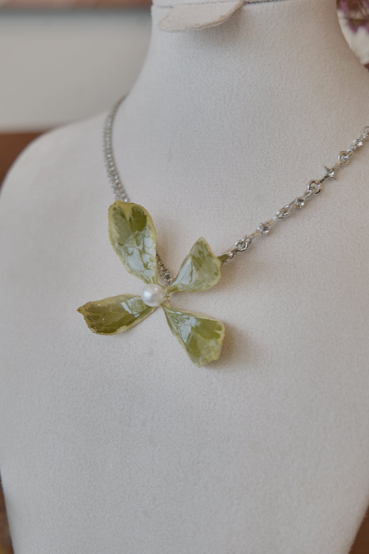 chain and charm detail of Golden Edge Euonymus leaf floral pendant necklace, handmade botanical jewellery by Terra Decode