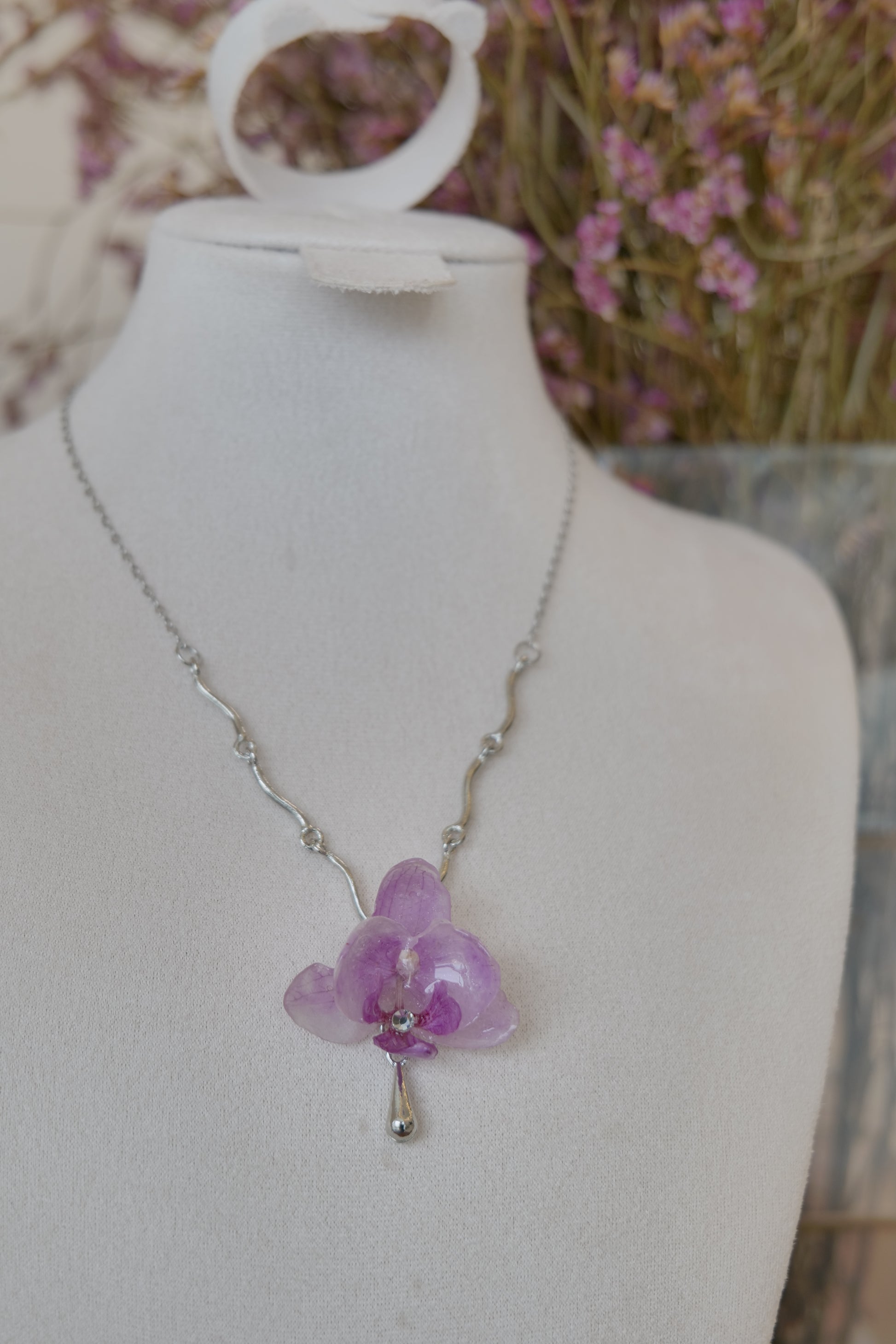 flower close-up of purple Phalaenopsis orchid charm necklace, handmade botanical jewellery by Terra Decode