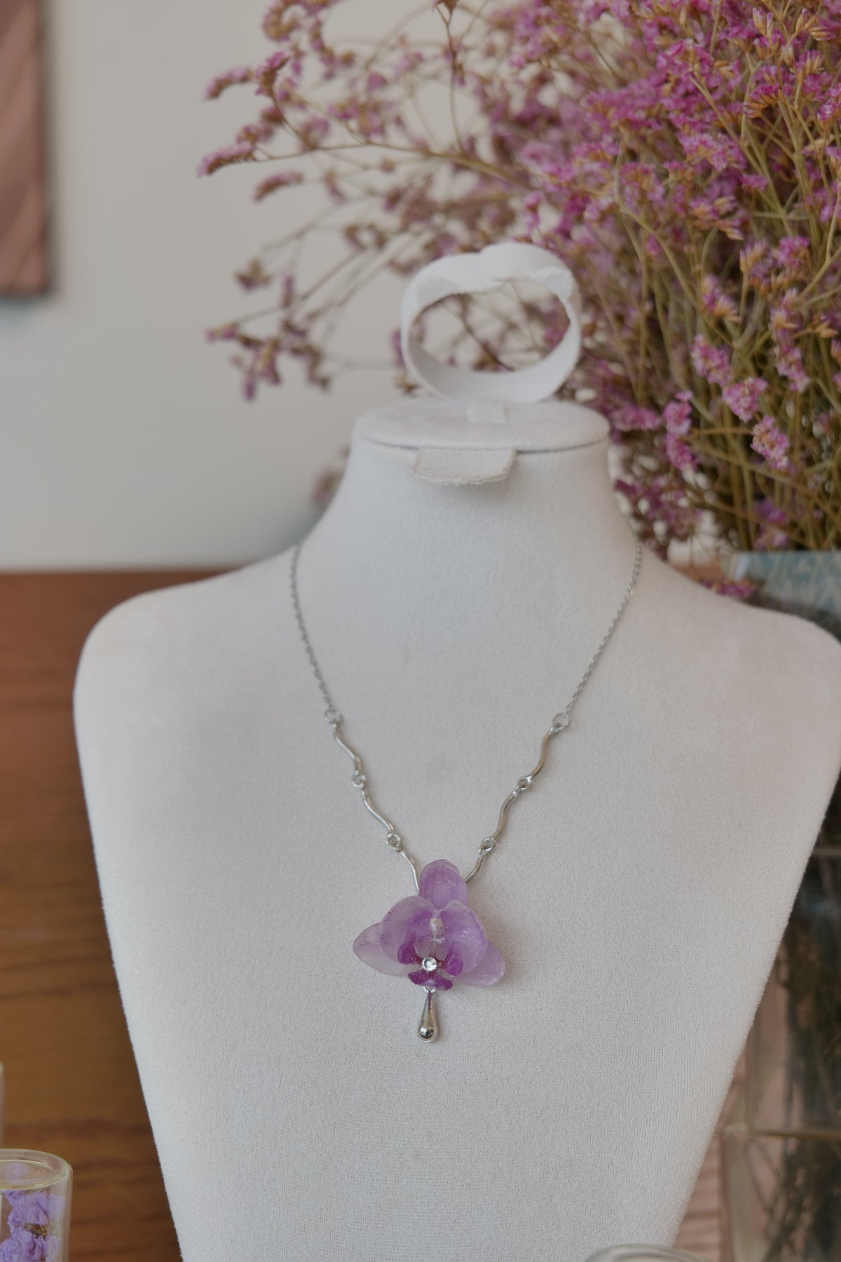 styled front view of purple Phalaenopsis orchid charm necklace, handmade botanical jewellery by Terra Decode