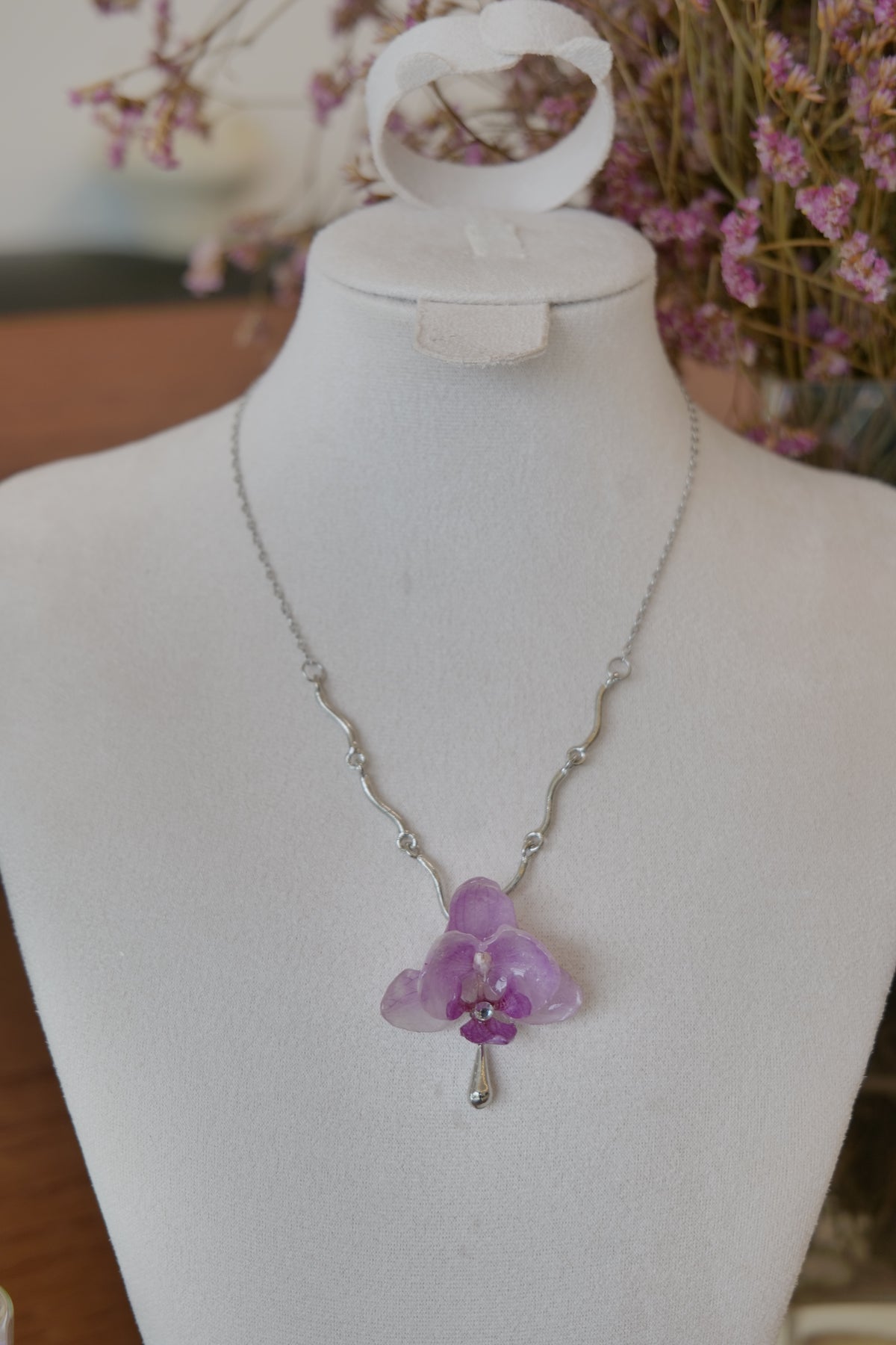 pendant detail of purple Phalaenopsis orchid charm necklace, handmade botanical jewellery by Terra Decode