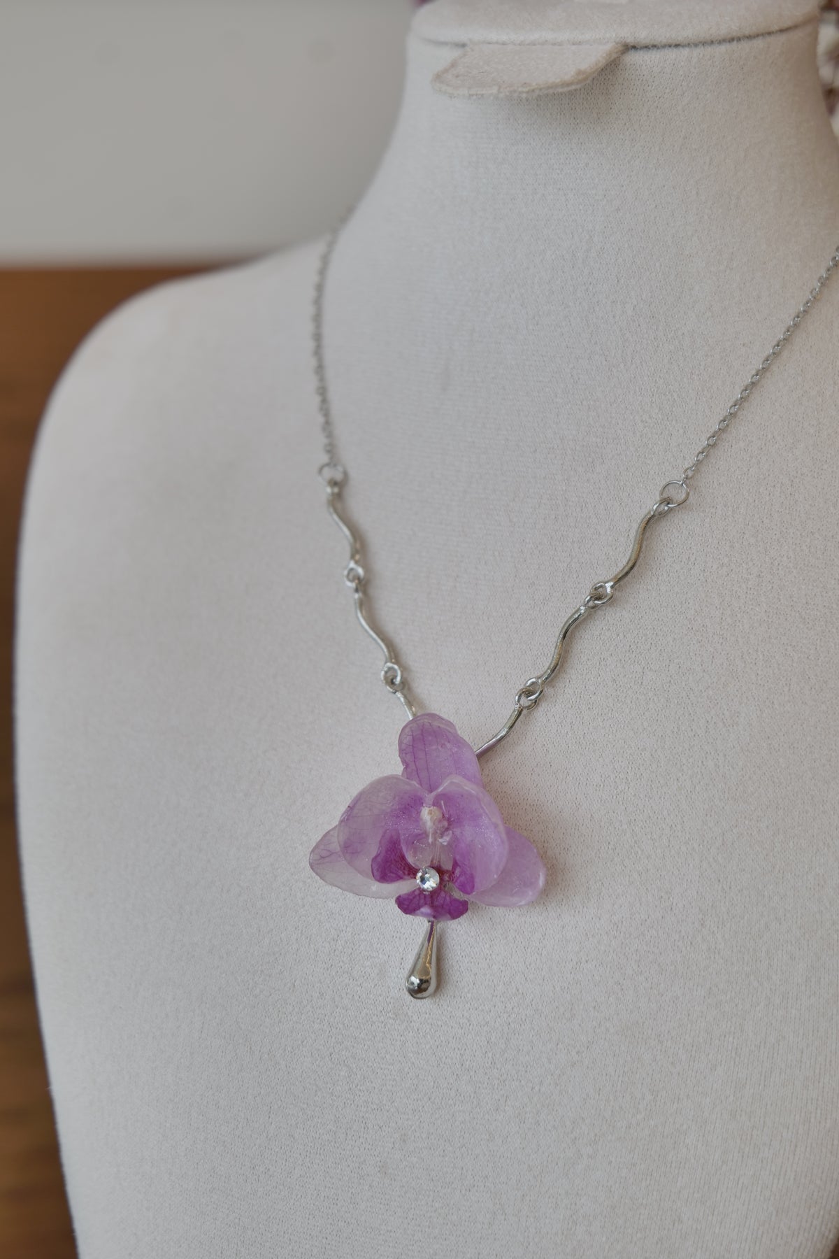 chain and charm detail of purple Phalaenopsis orchid charm necklace, handmade botanical jewellery by Terra Decode