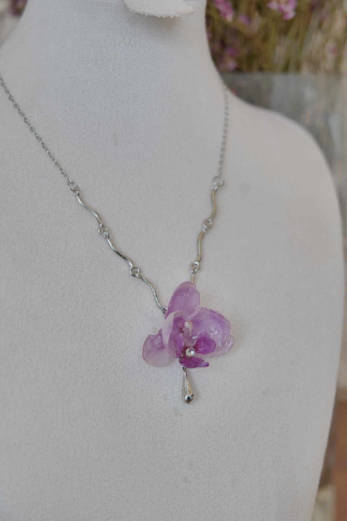 side view of purple Phalaenopsis orchid charm necklace, handmade botanical jewellery by Terra Decode