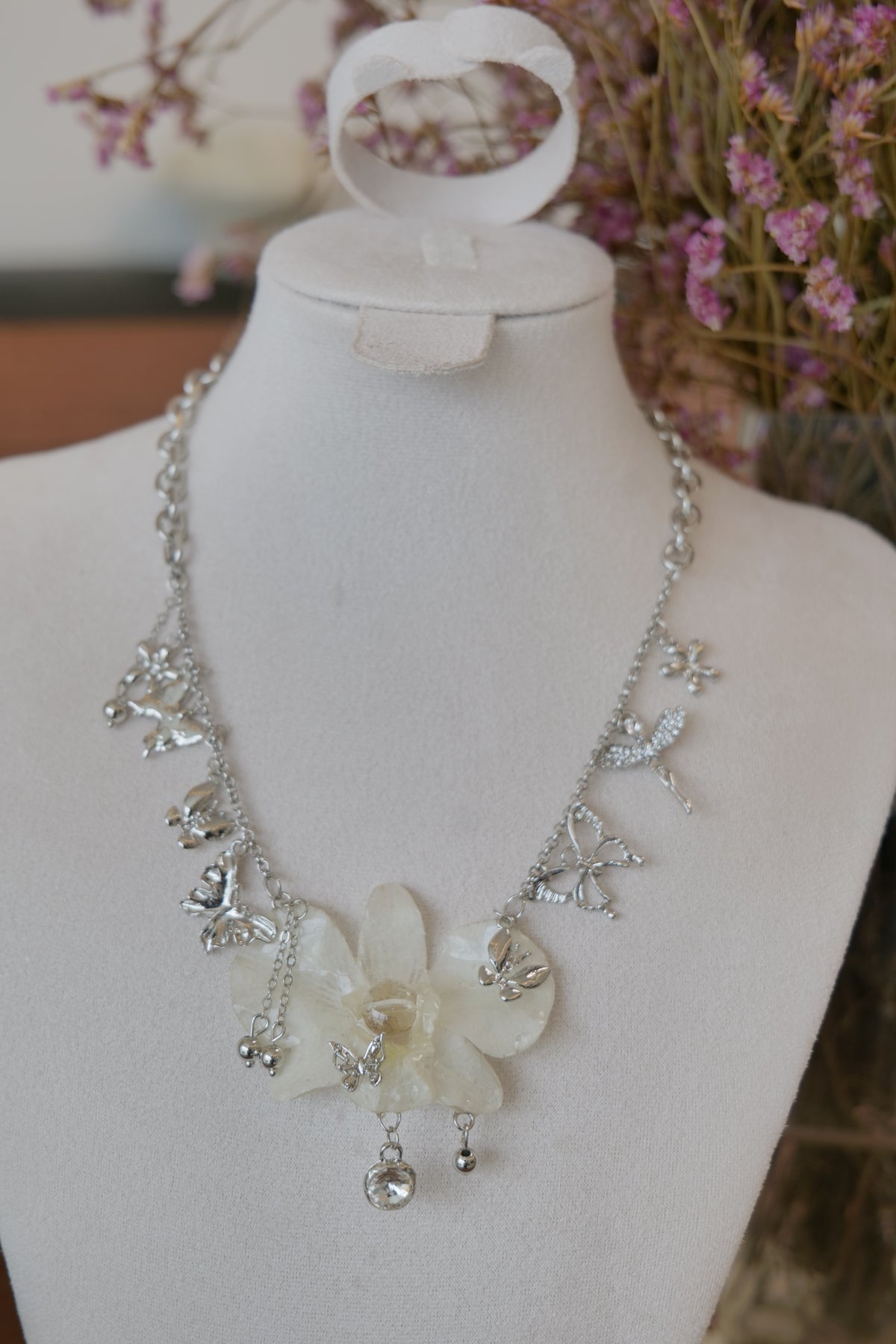 front view of white Dendrobium orchid statement necklace, handmade botanical jewellery by Terra Decode