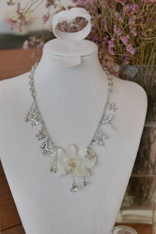 styled front view of white Dendrobium orchid statement necklace, handmade botanical jewellery by Terra Decode