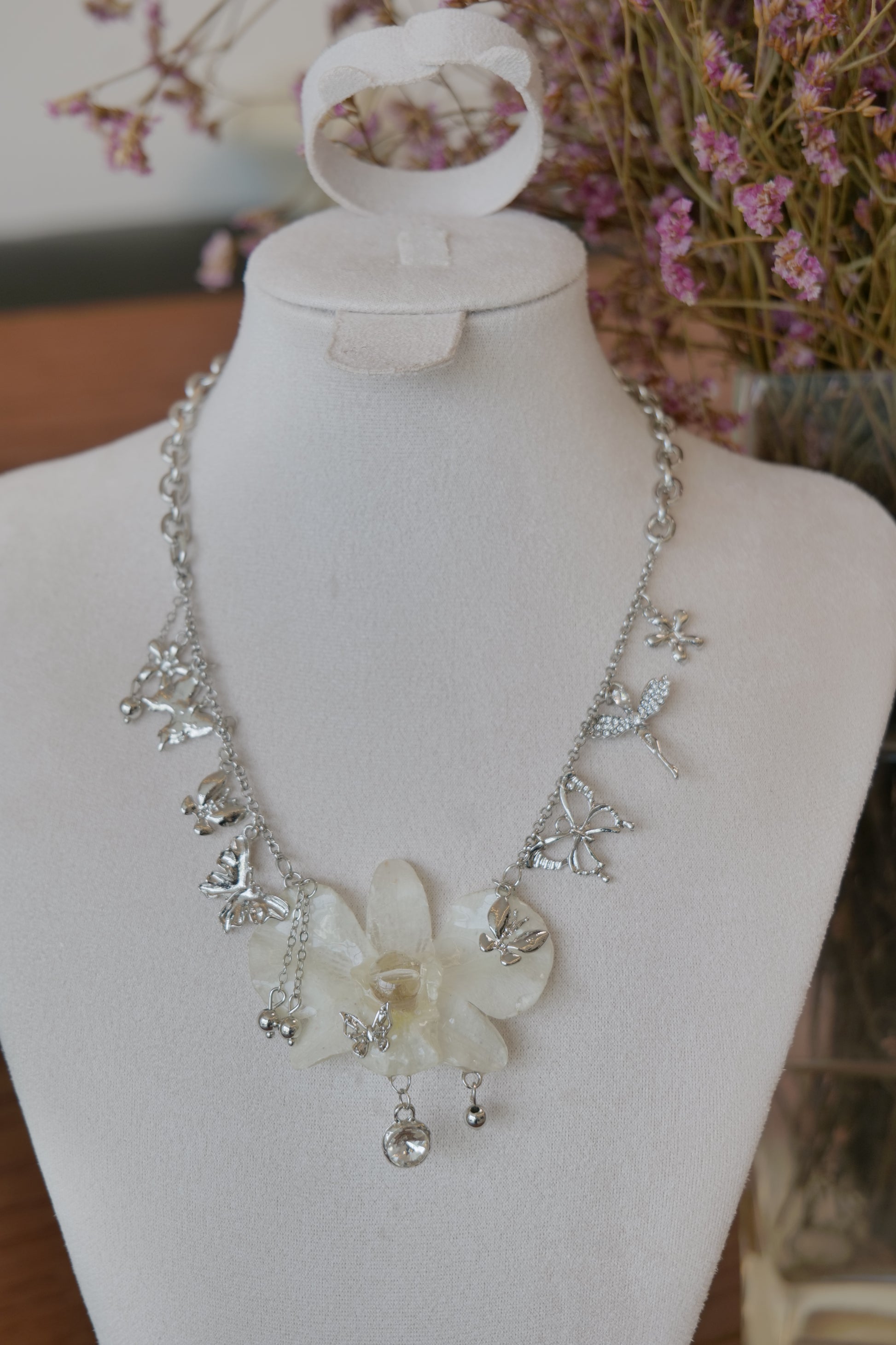 side view of white Dendrobium orchid statement necklace, handmade botanical jewellery by Terra Decode