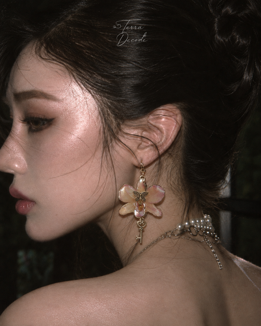 CLAVIELLE Purple Dendrobium Orchid Key & Butterfly Earrings worn by a model | Terra Decode