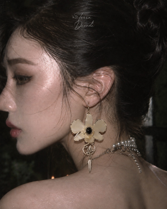NOCTELLA White Dendrobium Orchid Butterfly & Black Rhinestone Earrings worn by a model | Terra Decode