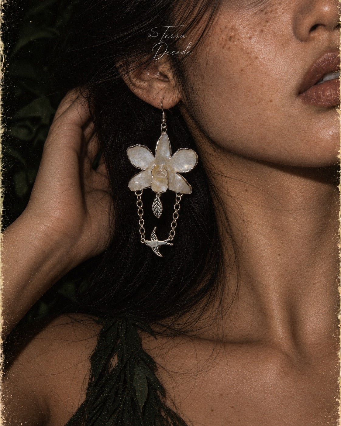 ALBION White Dendrobium Bird Dangle Earrings worn by a model | Terra Decode