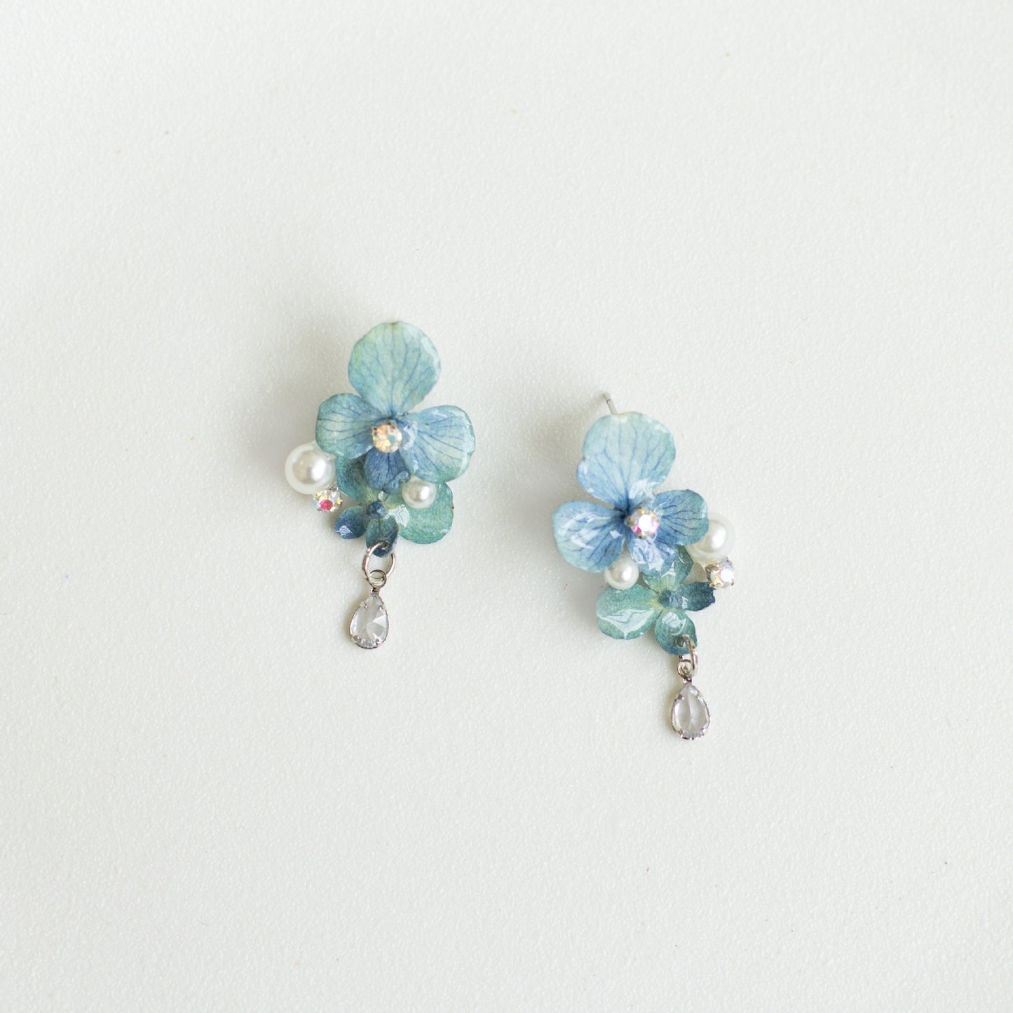 Hydrangea Blue hydrangea earrings with resin flower petals and silver-tone hooks by Terra Decode