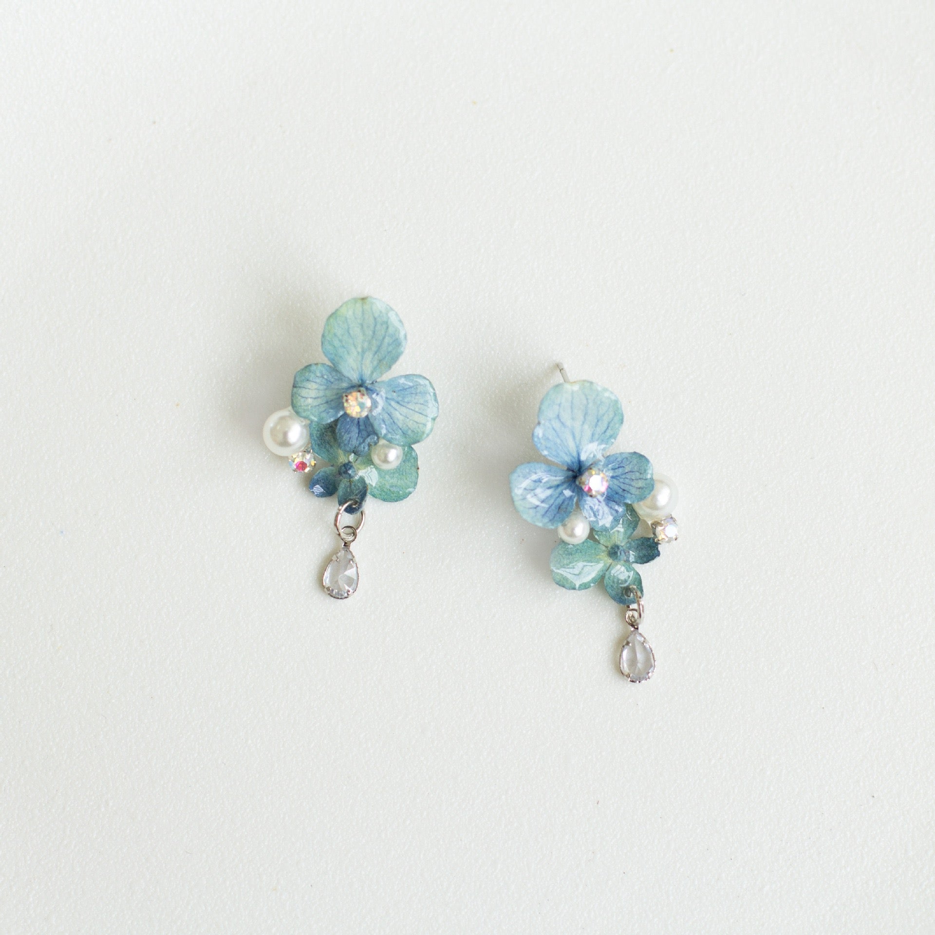 Hydrangea Blue hydrangea earrings with resin flower petals and silver-tone hooks by Terra Decode
