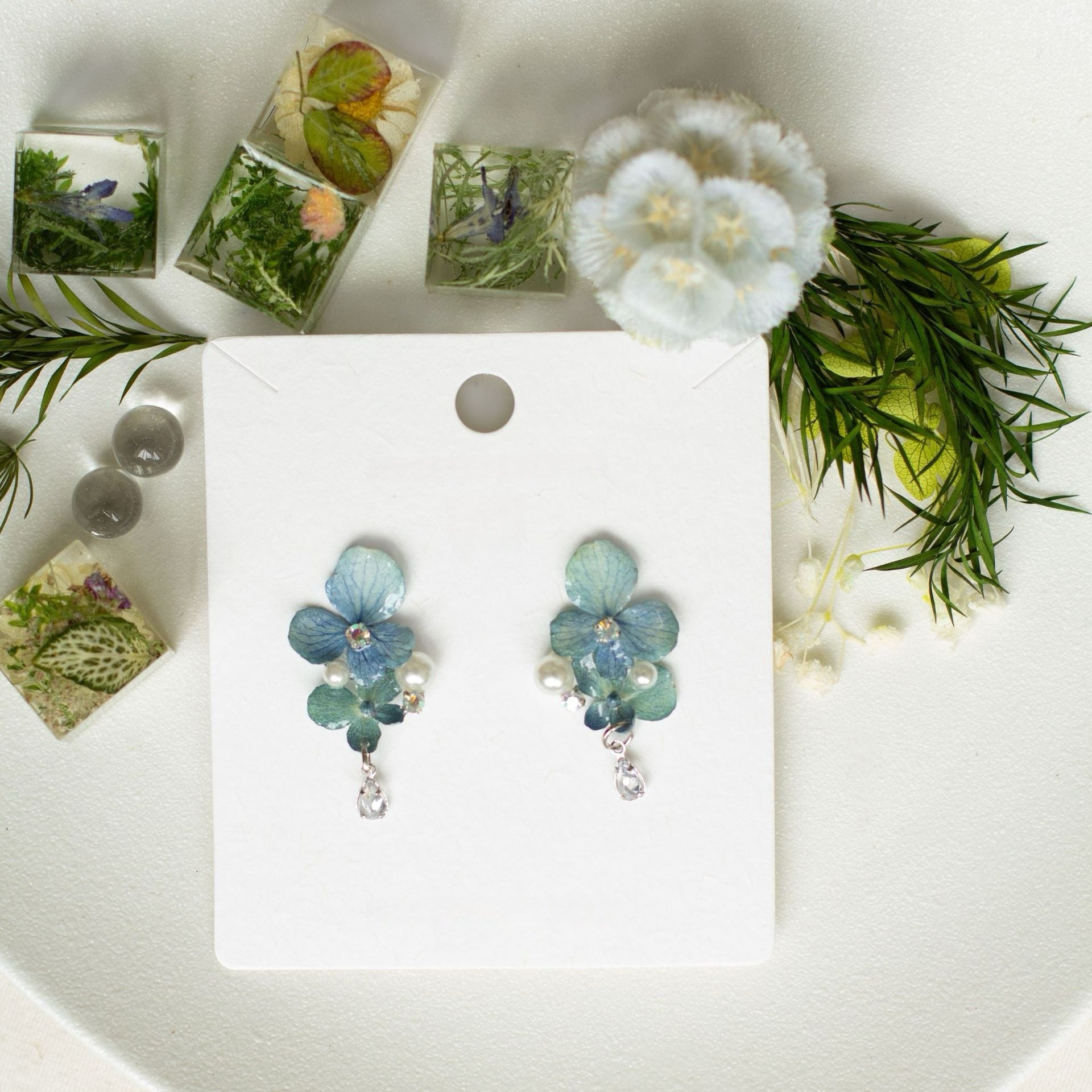 Hydrangea blue hydrangea earrings with resin petals and botanical styling by Terra Decode