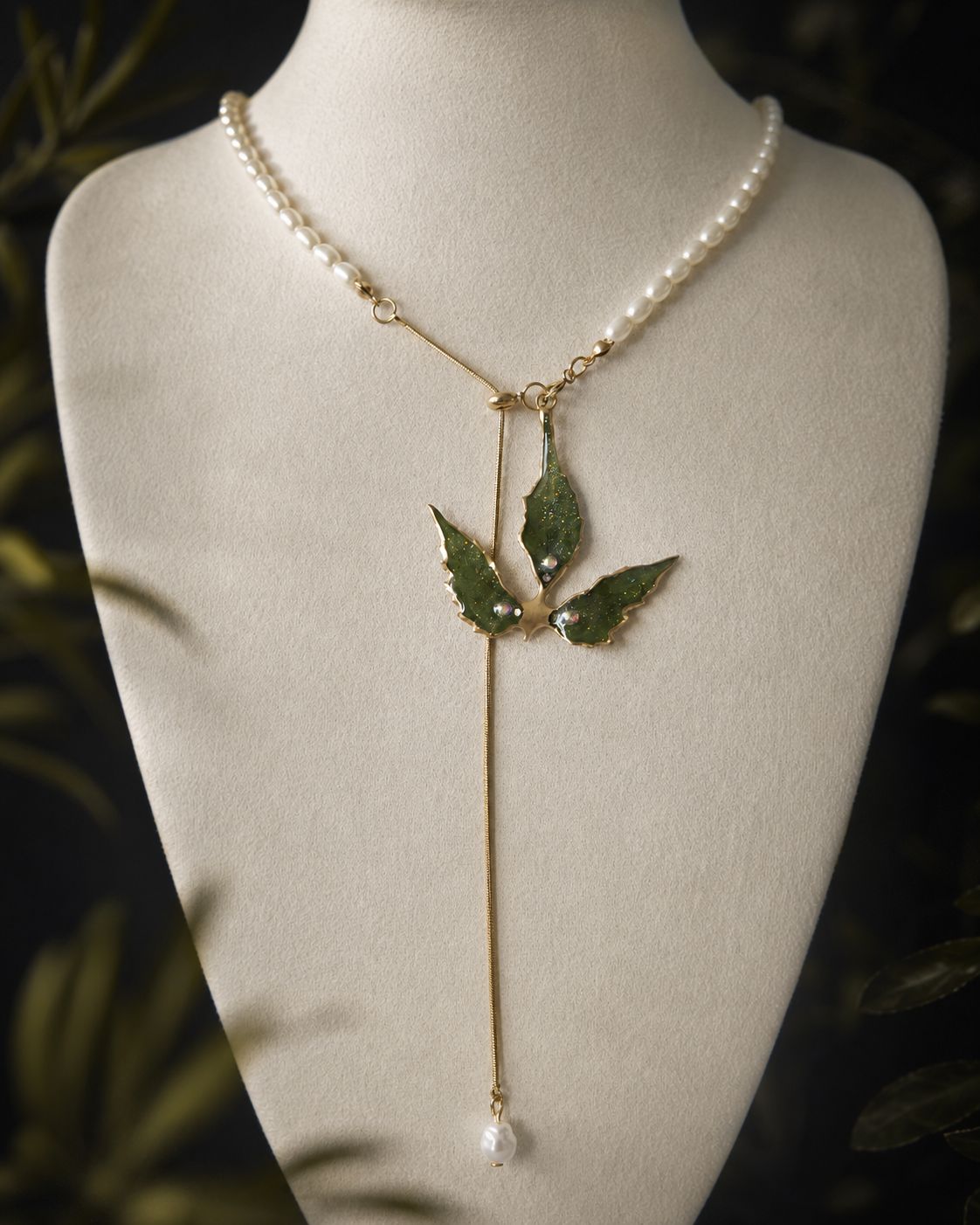 Angled view of the real Boston ivy pendant and asymmetric imitation-pearl chain, Boston Ivy Pearl-Drop Split-Chain Necklace botanical jewellery by Terra Decode
