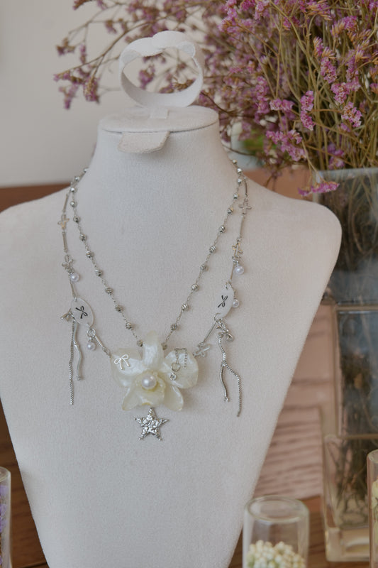 front view of cream Dendrobium orchid pearl necklace, handmade botanical jewellery by Terra Decode