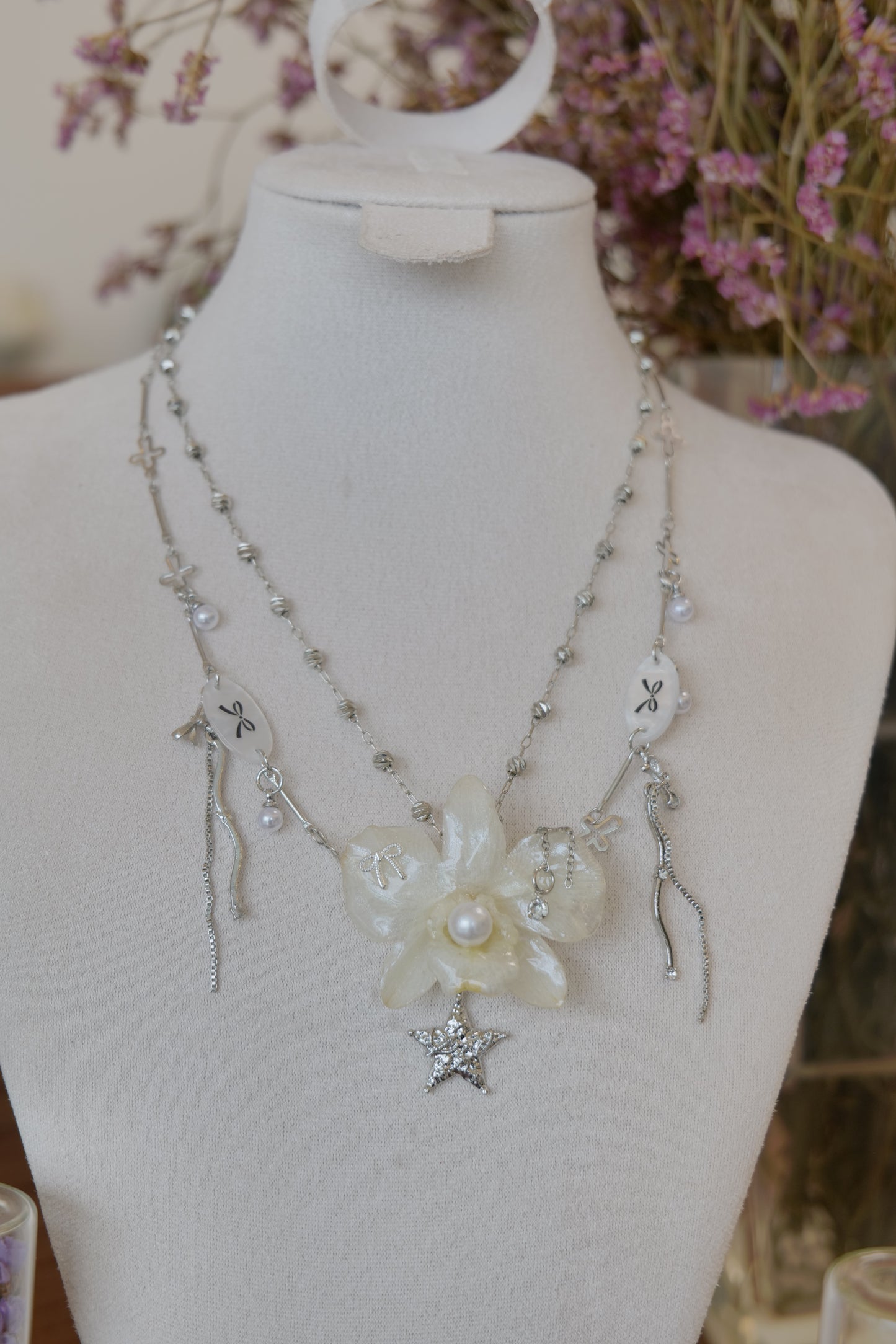 pendant detail of cream Dendrobium orchid pearl necklace, handmade botanical jewellery by Terra Decode