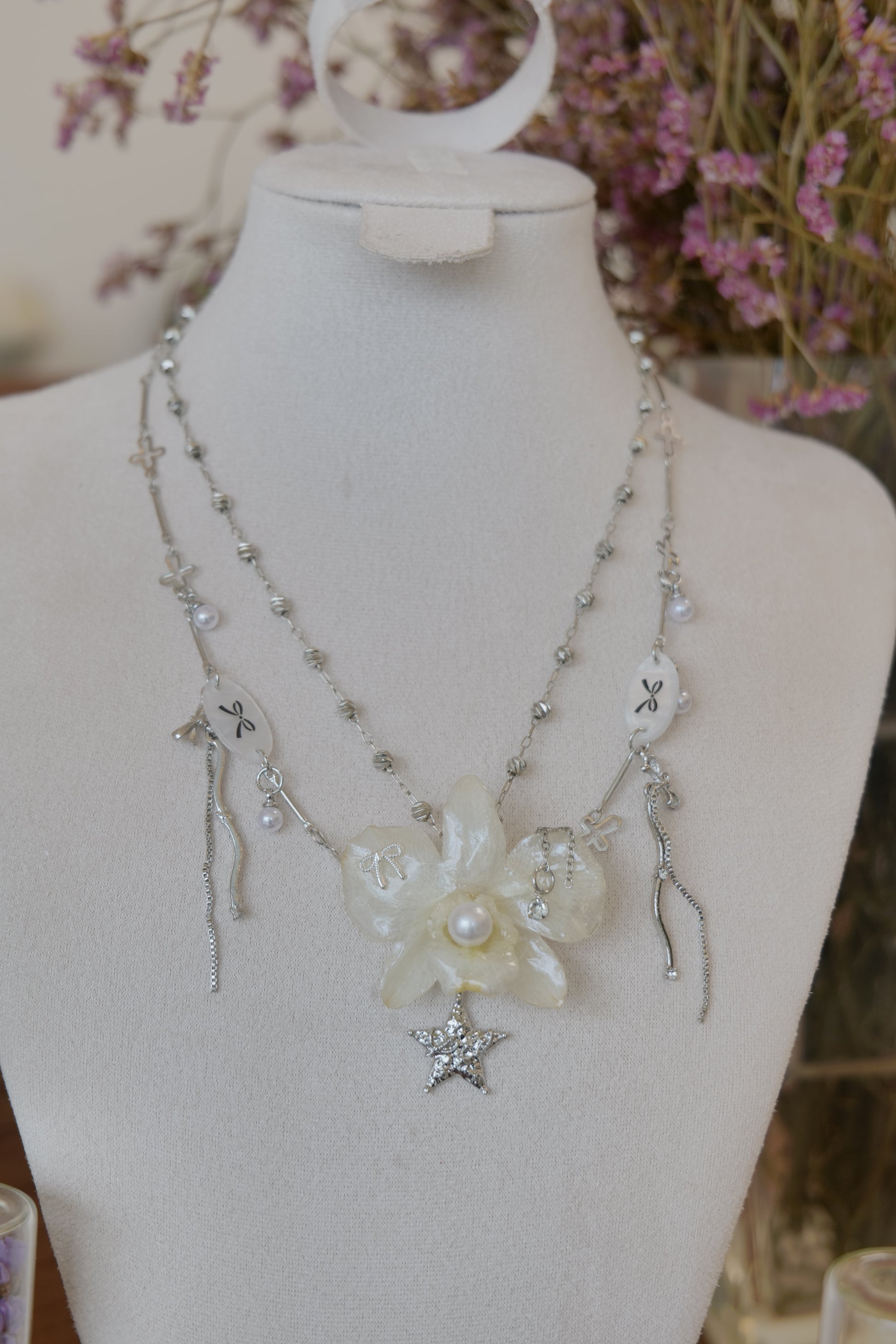 pendant detail of cream Dendrobium orchid pearl necklace, handmade botanical jewellery by Terra Decode
