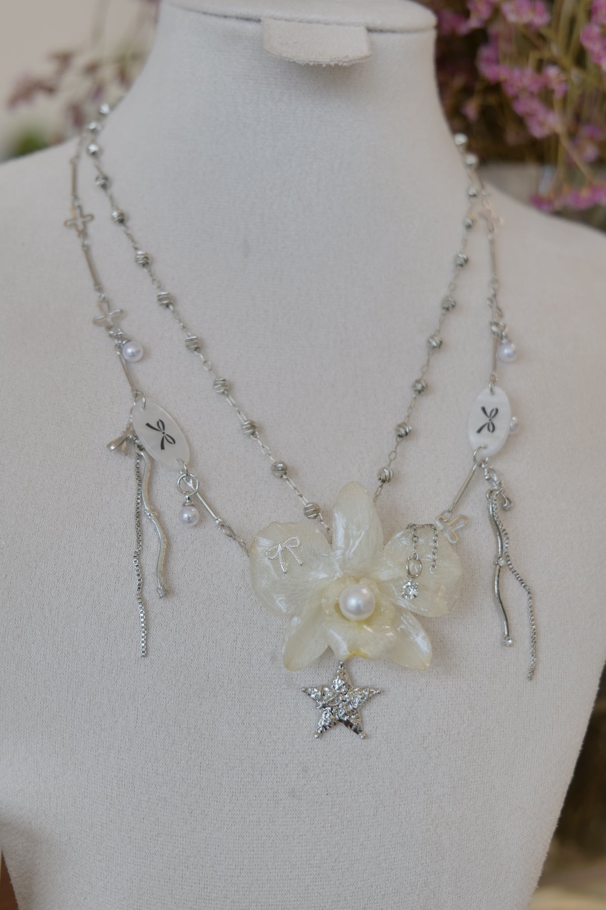 chain and charm detail of cream Dendrobium orchid pearl necklace, handmade botanical jewellery by Terra Decode