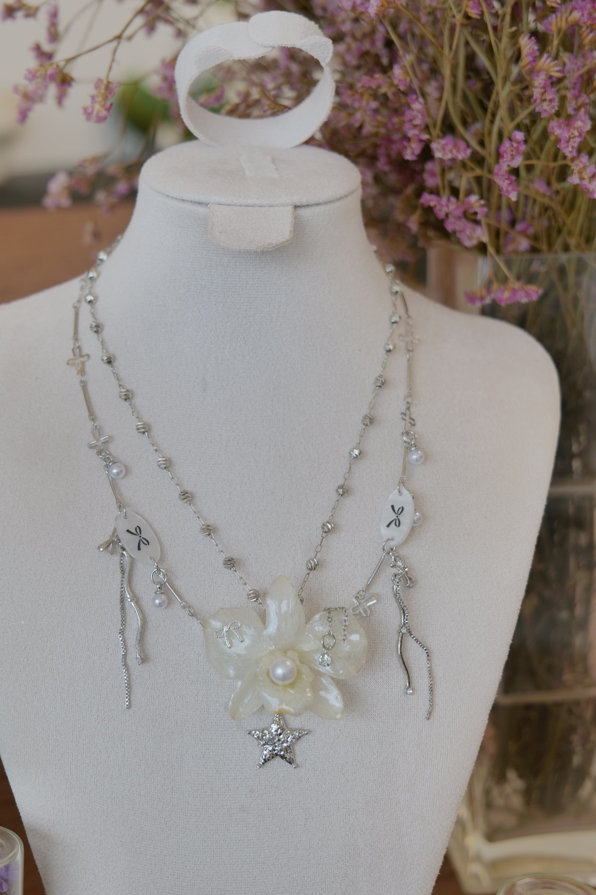 botanical detail of cream Dendrobium orchid pearl necklace, handmade botanical jewellery by Terra Decode