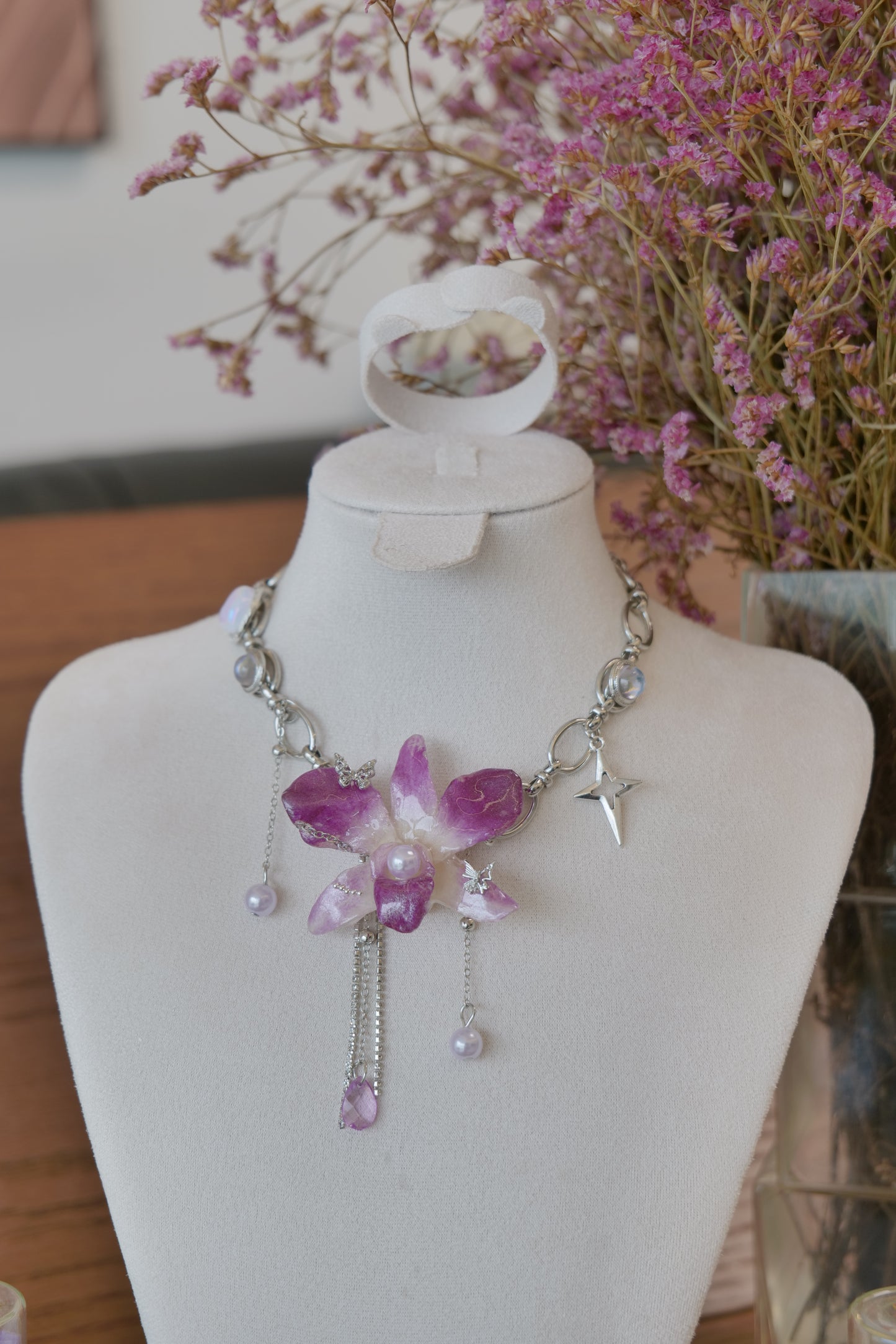 styled front view of purple Dendrobium orchid pearl charm choker necklace, handmade botanical jewellery by Terra Decode