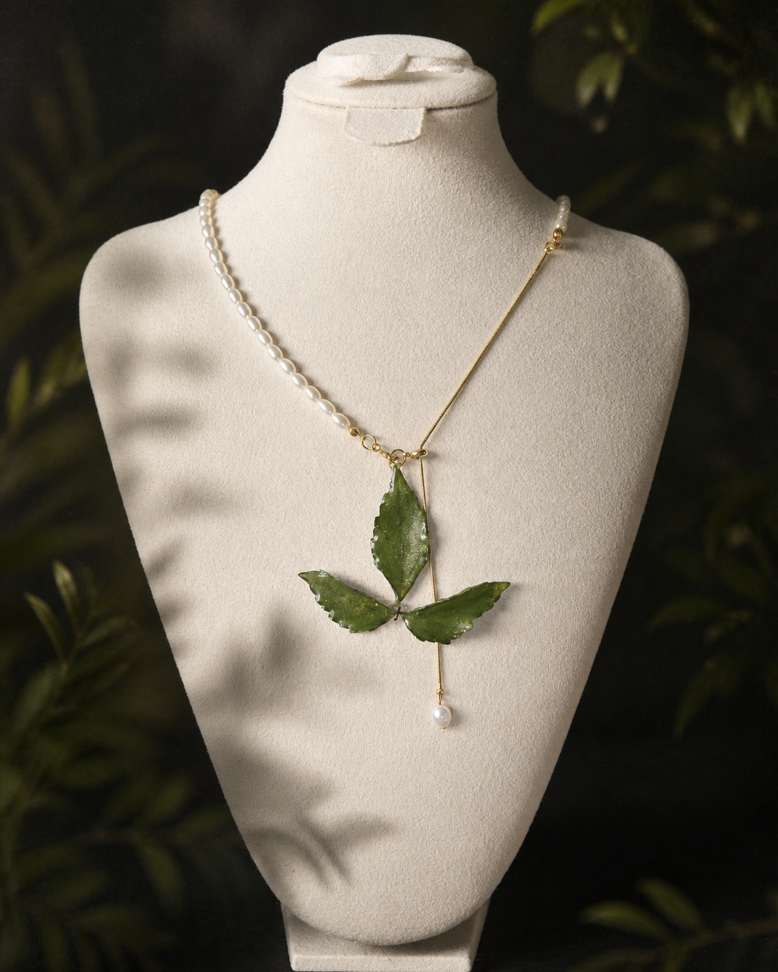 Close-up of Boston ivy leaves suspended in clear resin, Clear Boston Ivy Pearl-Drop Necklace botanical jewellery by Terra Decode