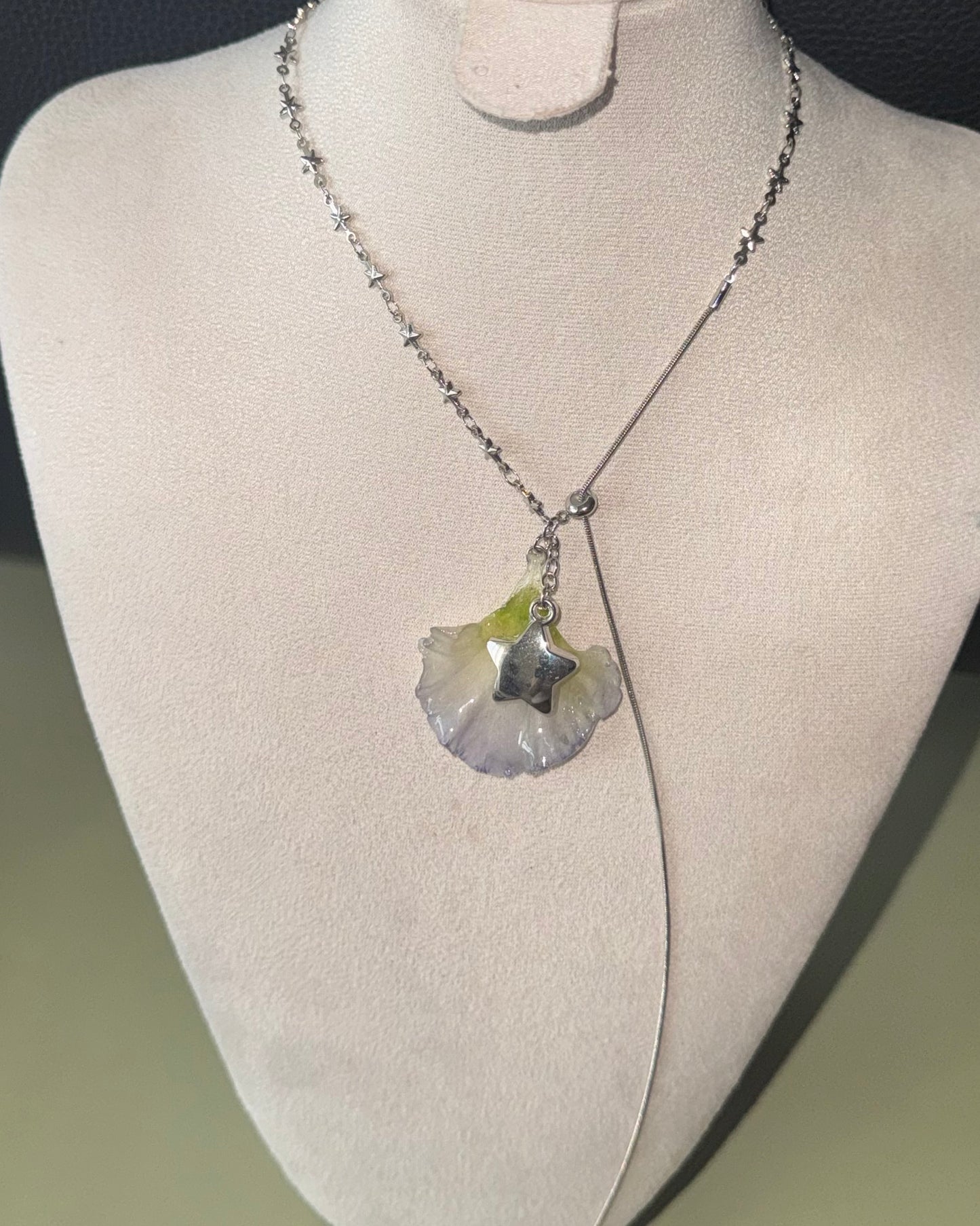 Double-lisianthus petal lariat with silver-toned star charm shown from the front