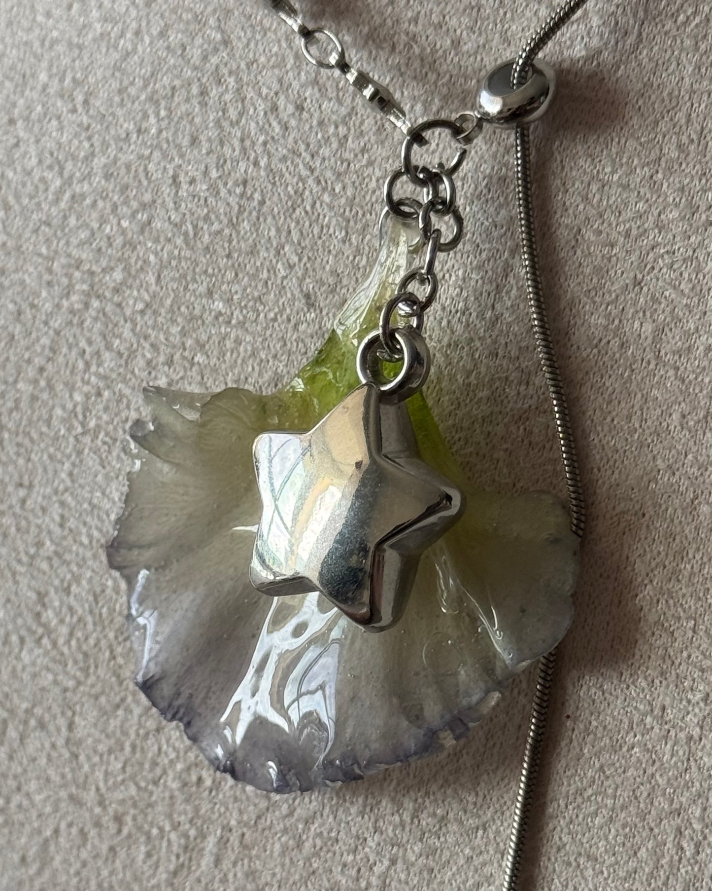 Close-up of pale green and lilac-edged lisianthus resin pendant