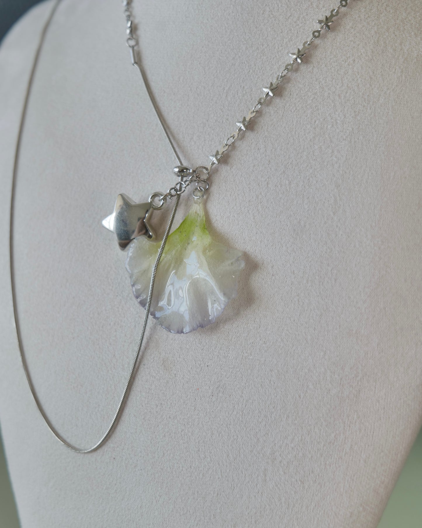 Angled view of the Double Lisianthus Star Adjustable Lariat Necklace showing asymmetric links
