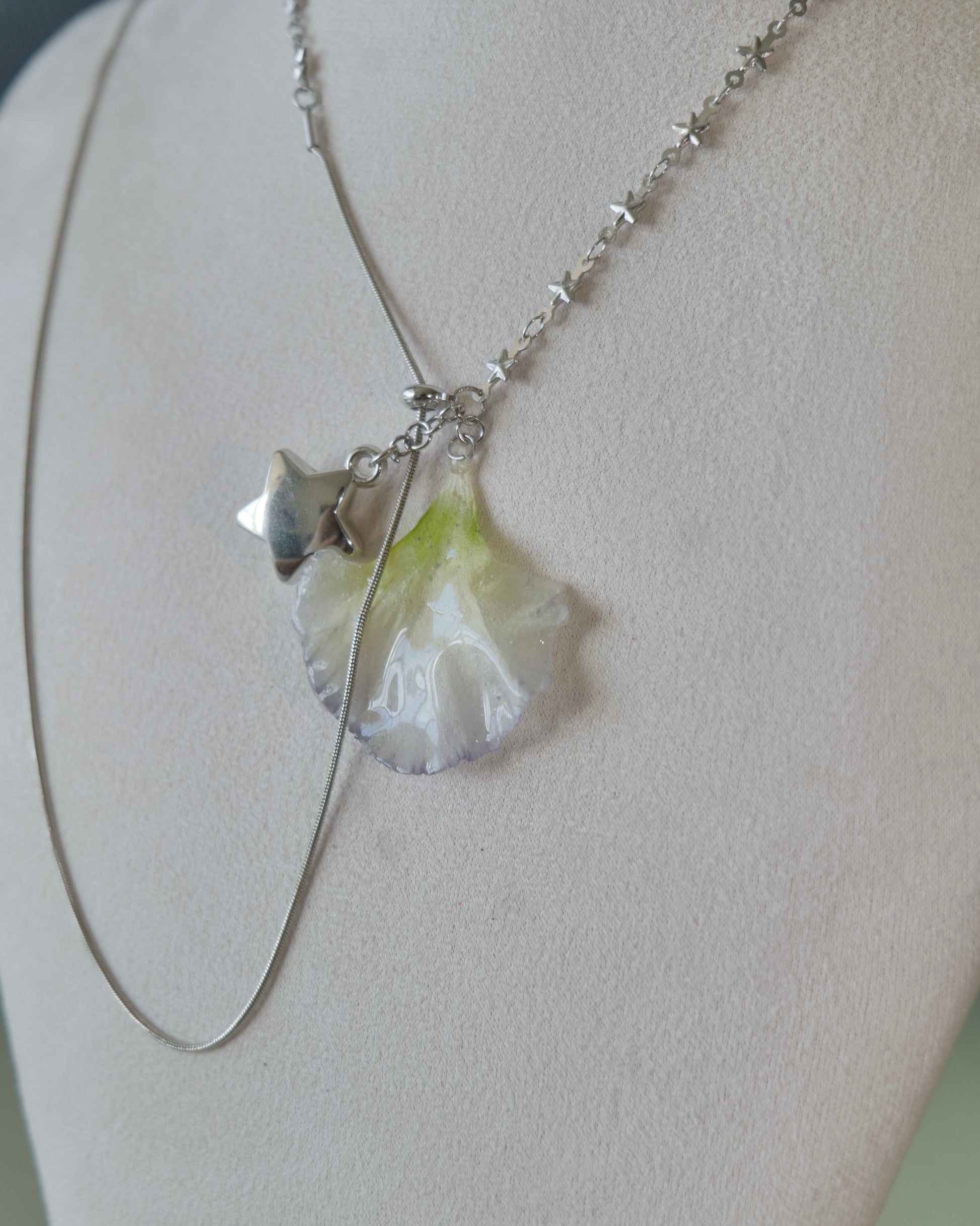 Angled view of the Double Lisianthus Star Adjustable Lariat Necklace showing asymmetric links