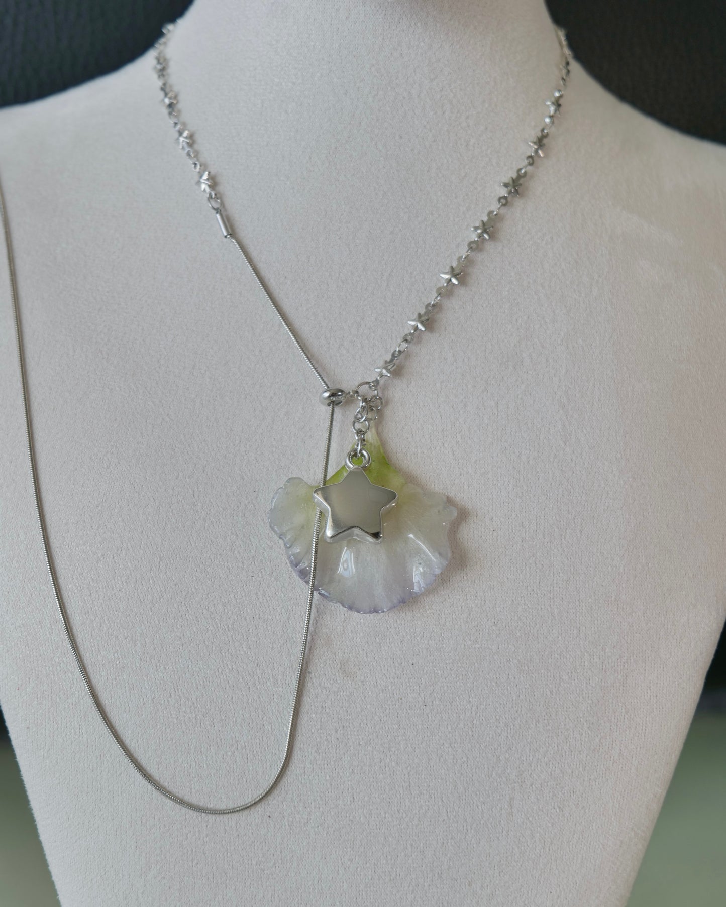 Natural-light front view of pale double-lisianthus petal necklace