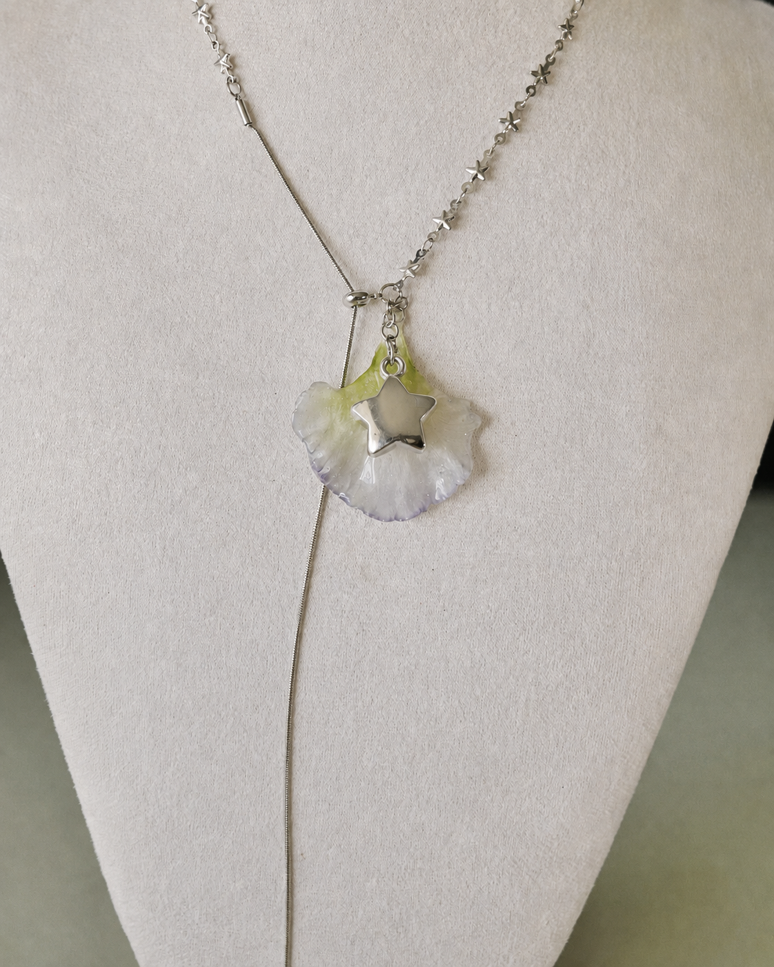 Angled view of the double-lisianthus petal pendant and silver-toned star charm, Double Lisianthus Star Adjustable Lariat Necklace botanical jewellery by Terra Decode