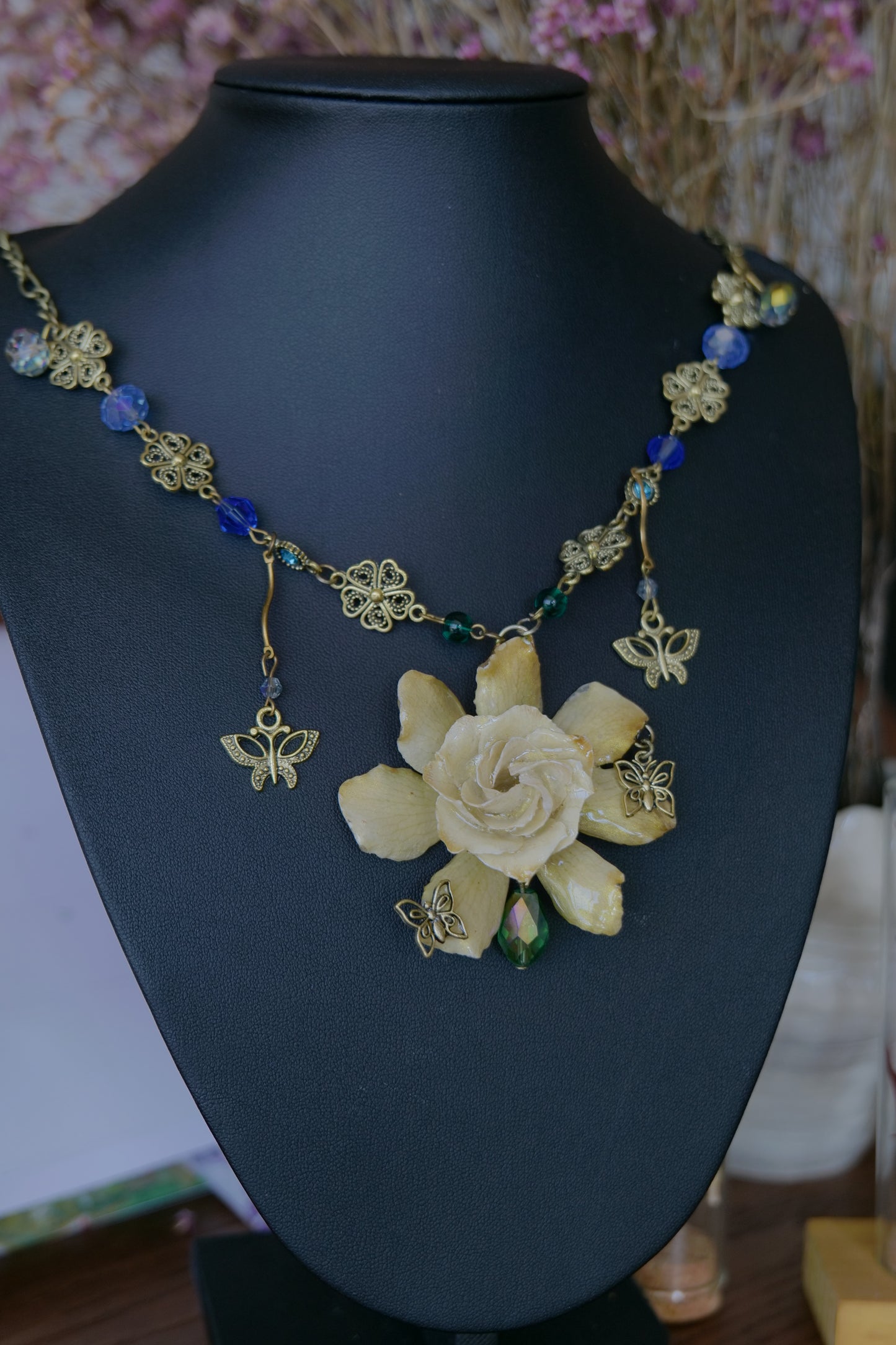 Full view of the one-of-a-kind preserved gardenia butterfly necklace