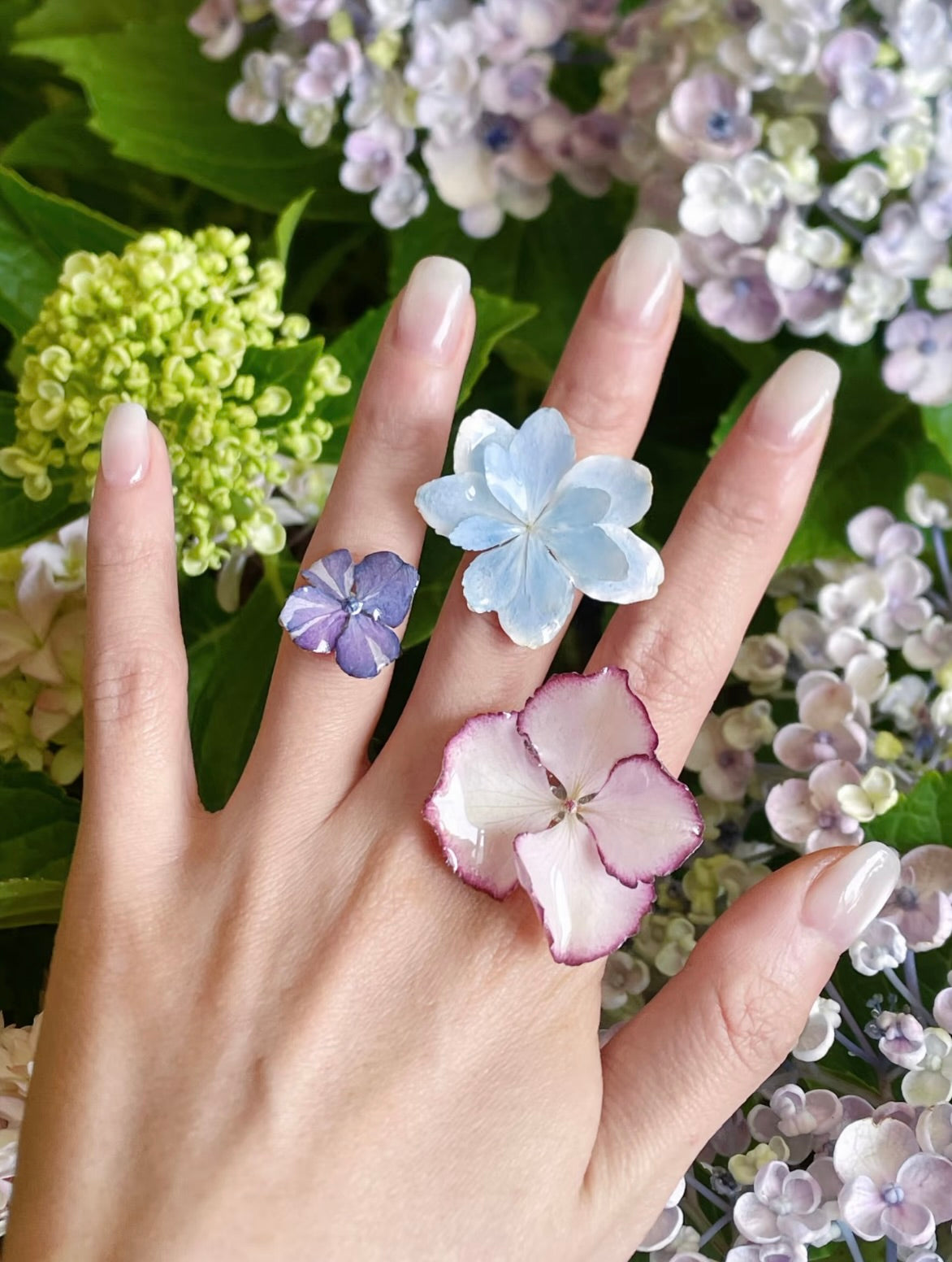 Lavender purple hydrangea ring with resin petals worn with garden hydrangeas by Terra Decode
