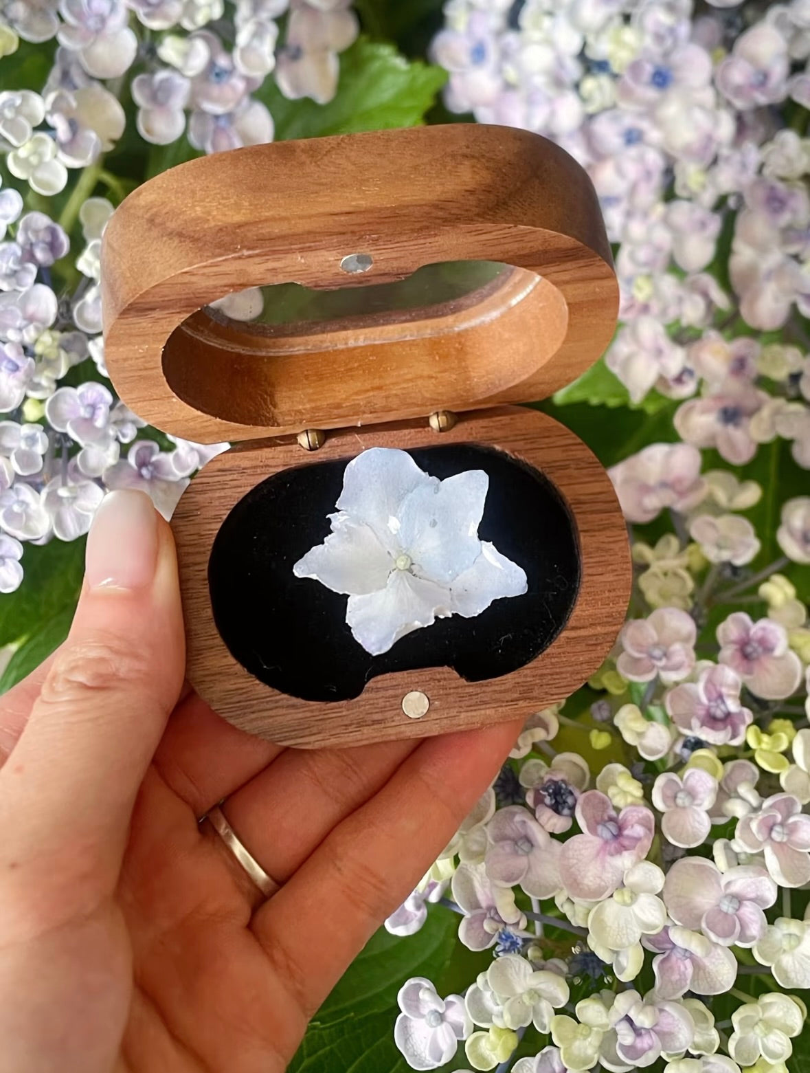 Cream white hydrangea ring with resin petals displayed in a wooden jewellery box by Terra Decode