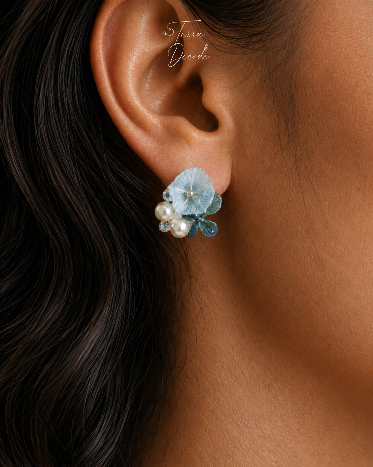 Icy blue hydrangea stud earring with pearl and crystal accents worn on ear