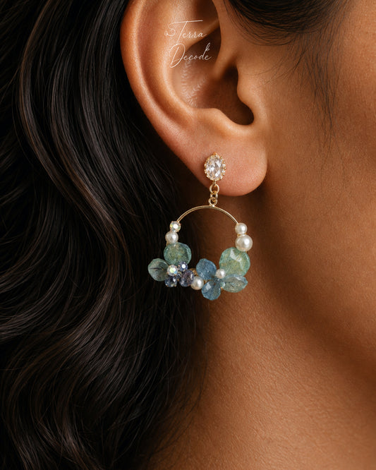 Blue hydrangea floral hoop drop earring with pearls worn on ear