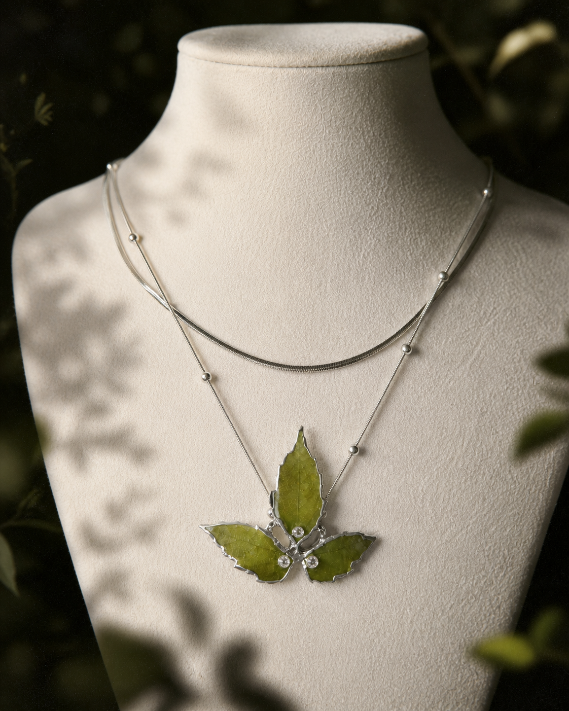 Left angled view of preserved Boston ivy leaves and layered silver-toned chains, Layered Silver Boston Ivy Botanical Necklace botanical jewellery by Terra Decode