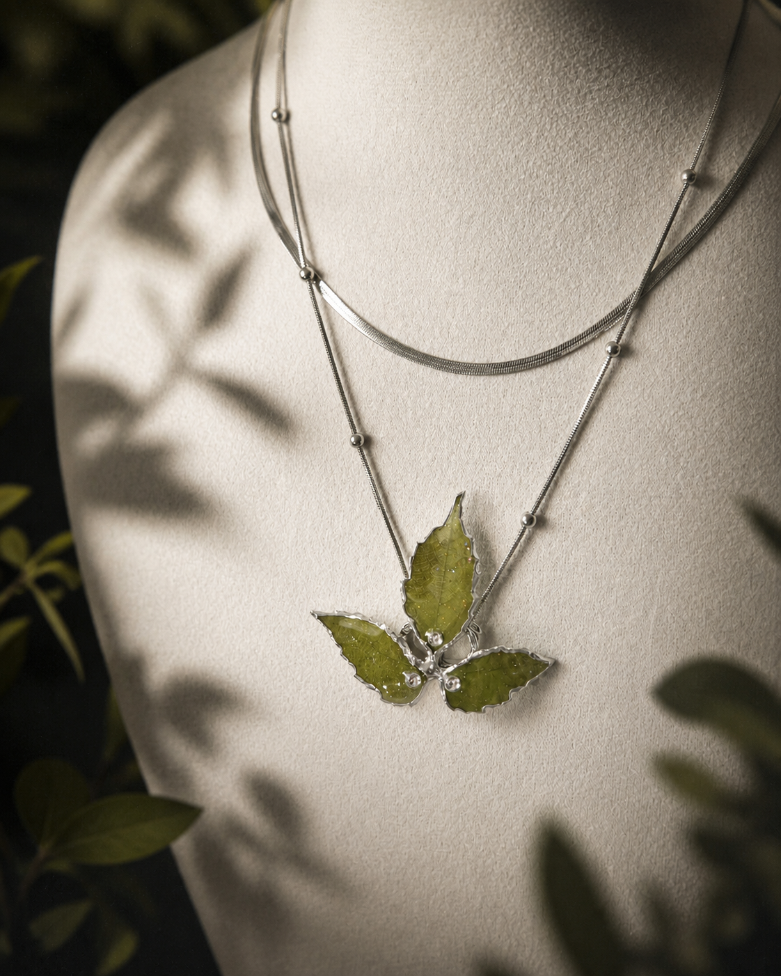 Right angled view of the real-leaf pendant and polished metal beads, Layered Silver Boston Ivy Botanical Necklace botanical jewellery by Terra Decode