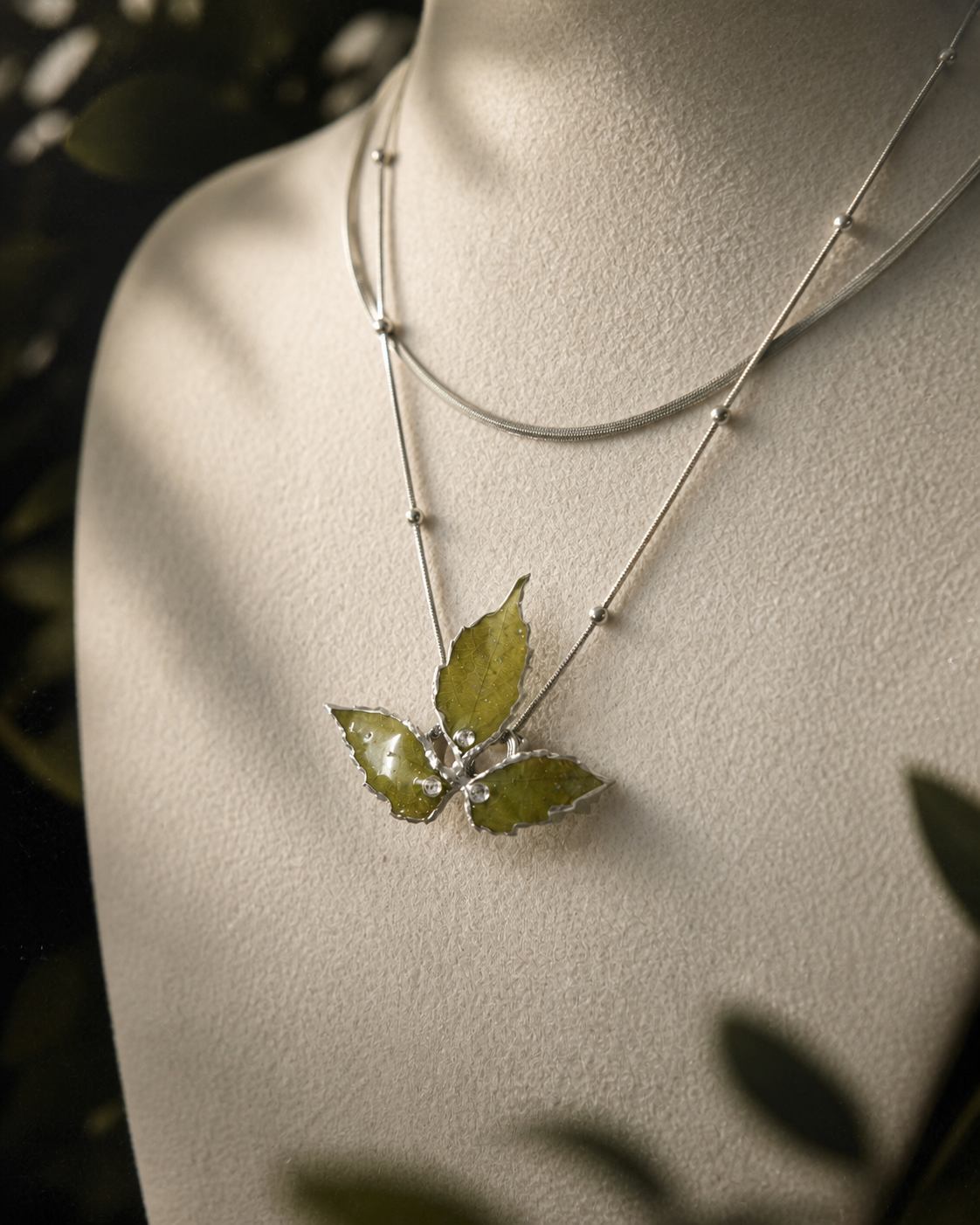 Full-length view of the layered botanical necklace on a cream jewellery bust, Layered Silver Boston Ivy Botanical Necklace botanical jewellery by Terra Decode