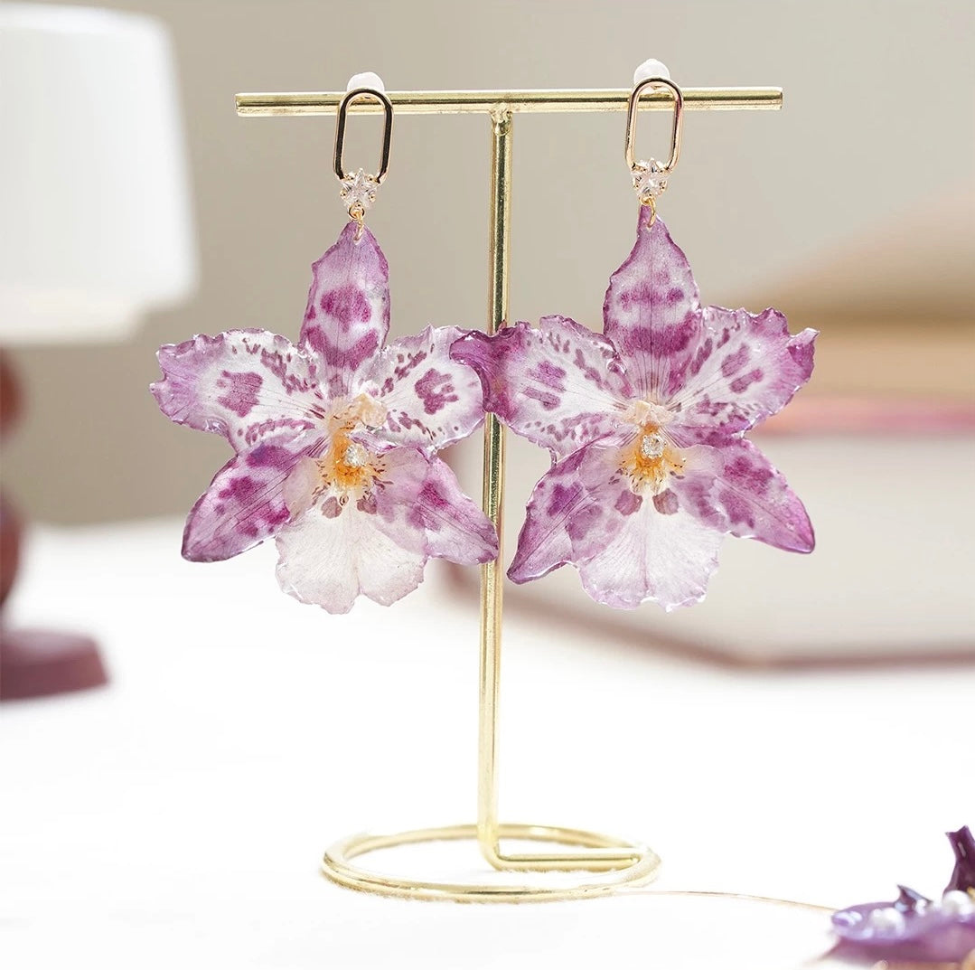 Spotted Purple orchid earrings with resin petals and gold-tone hooks by Terra Decode